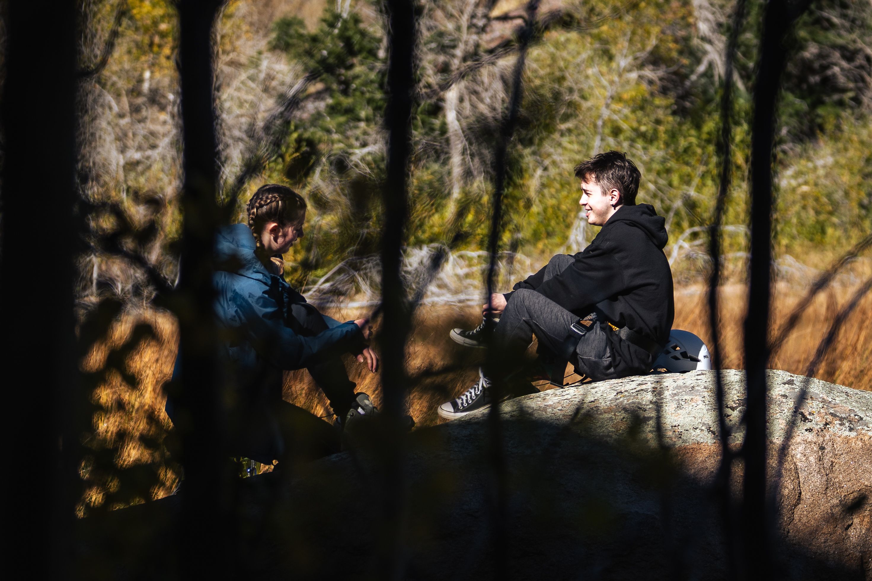 Students sitting on a rock at Kennedy Mountain Campus