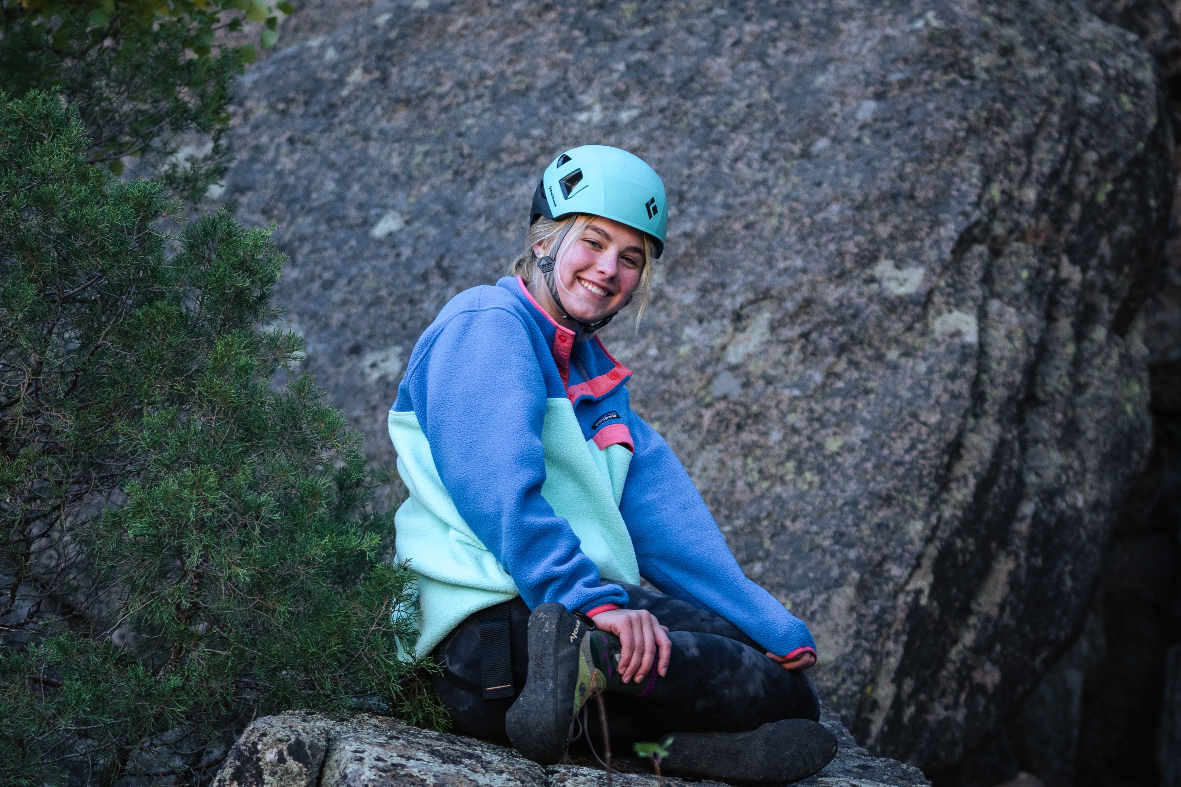 Student smiling while rock climbing