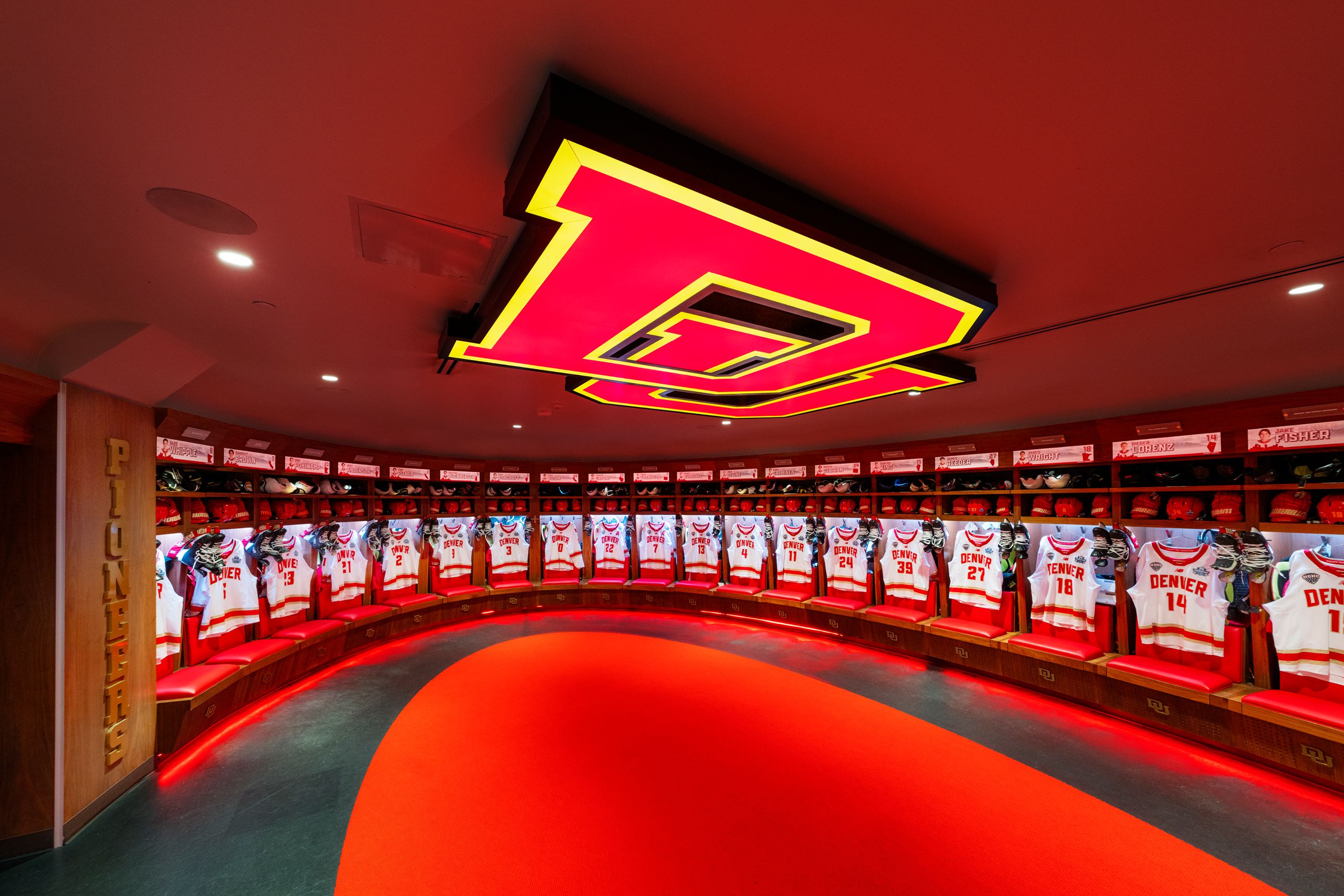 A wide shot of the DU hockey locker room with jerseys hanging in lockers