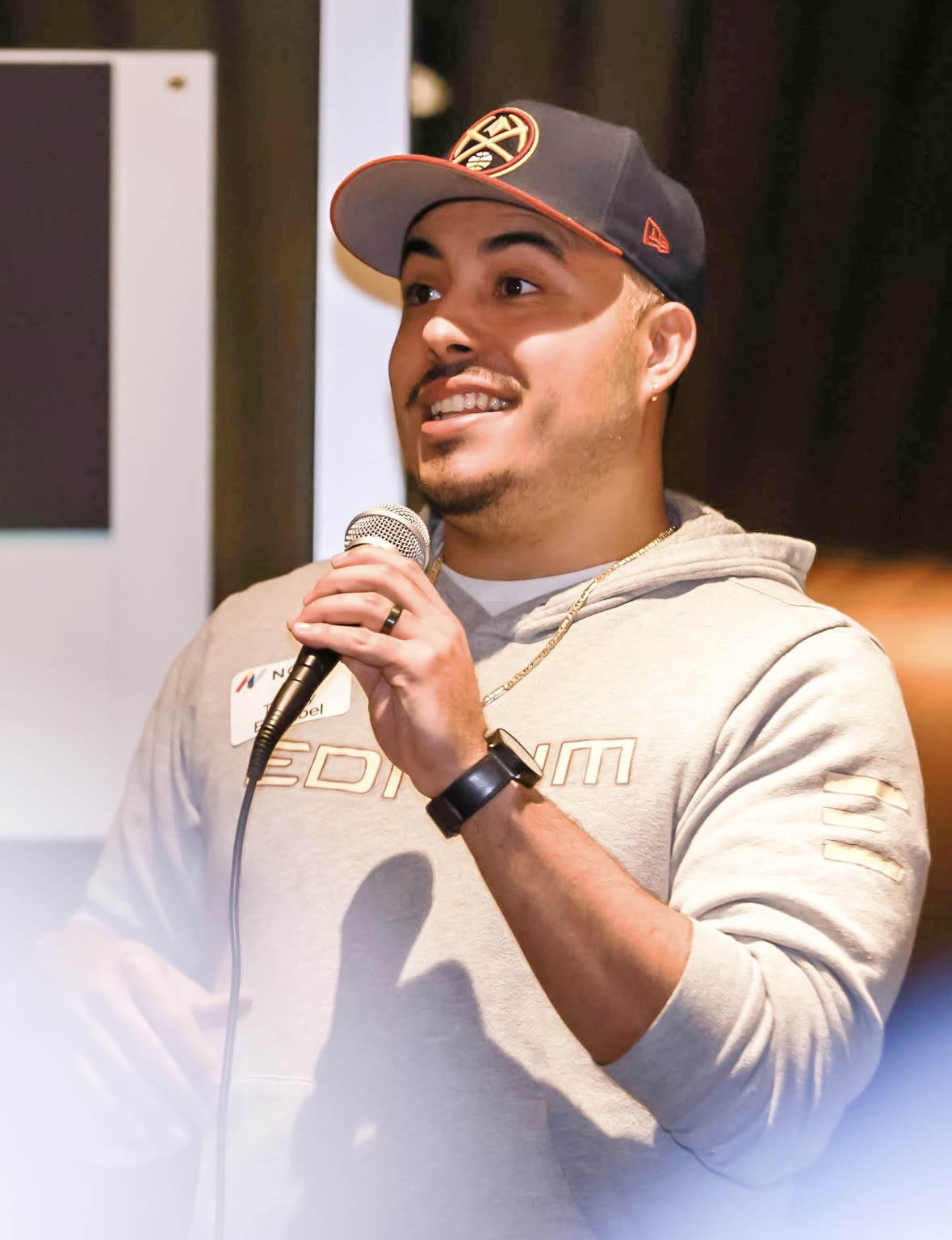 TeRay Esquibel speaks into a microphone