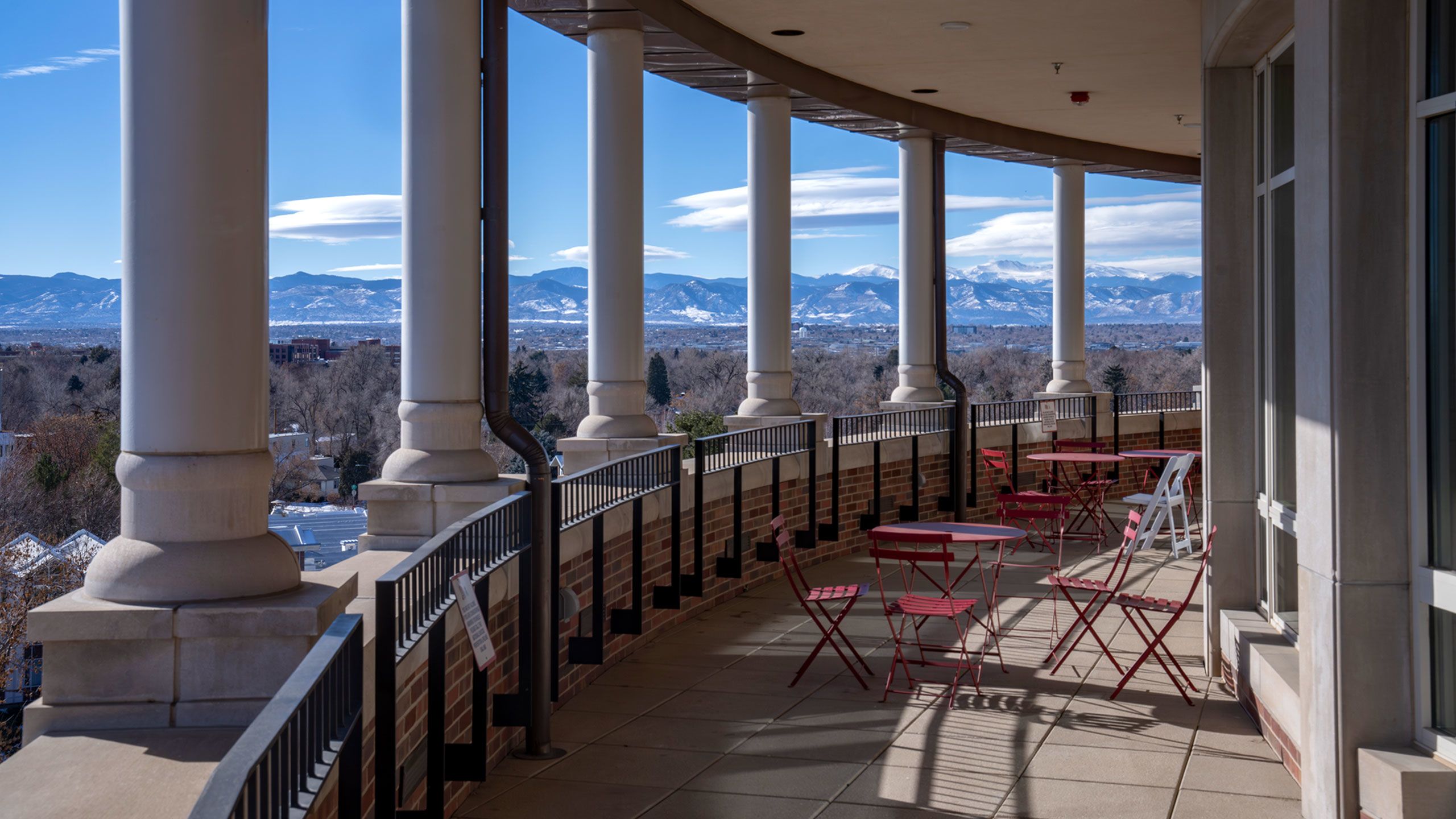columns on DU campus with mountains in background