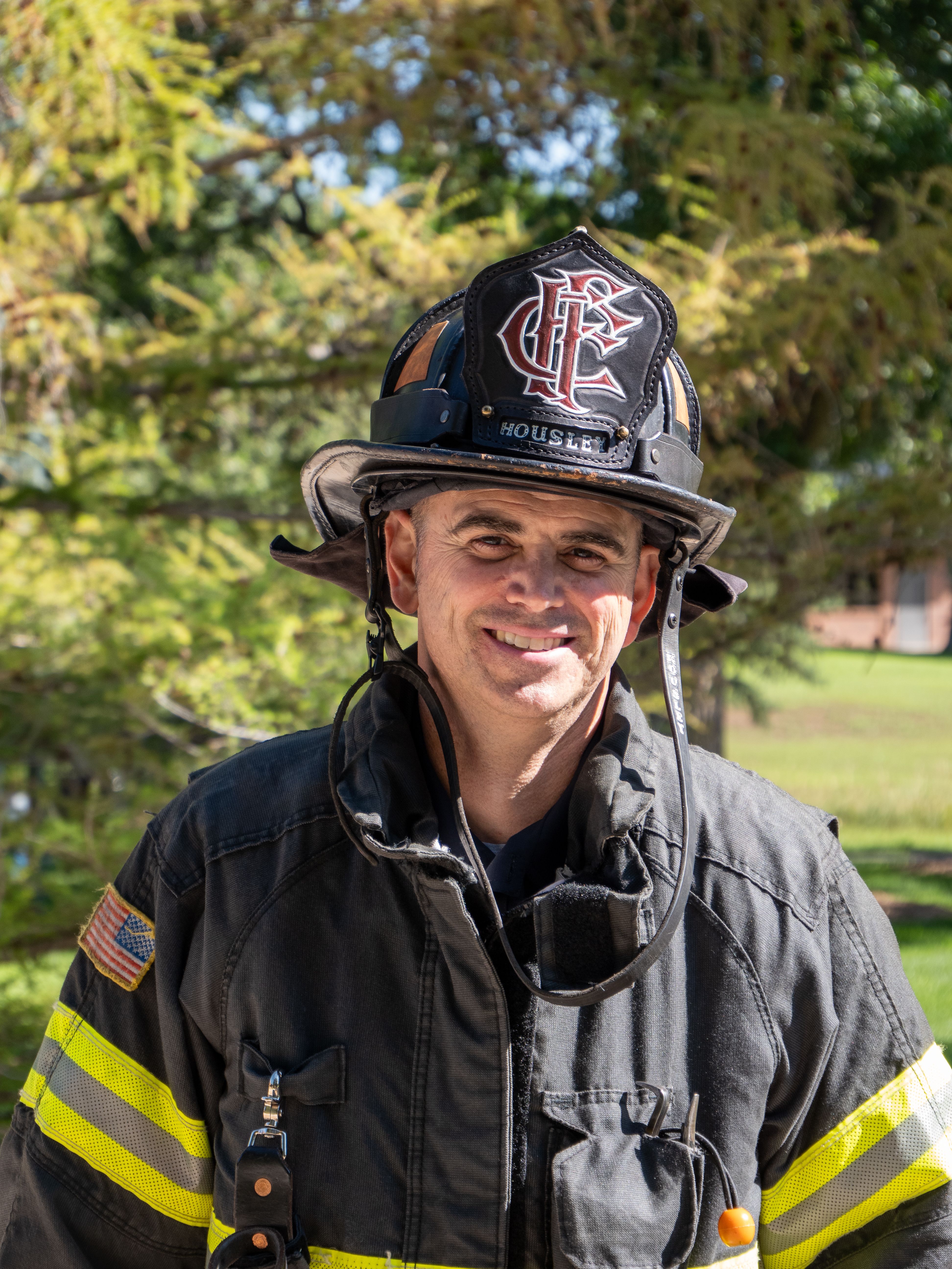 Kevin Housley in firefighting gear with trees in the background