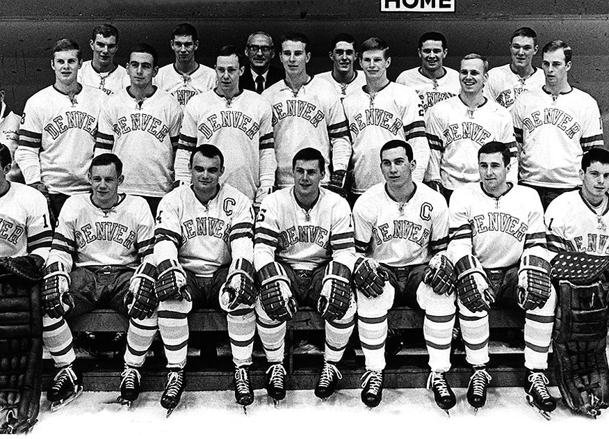 The University of Denver 1968 hockey team poses for a formal photo in their uniforms with the arched Denver logo.