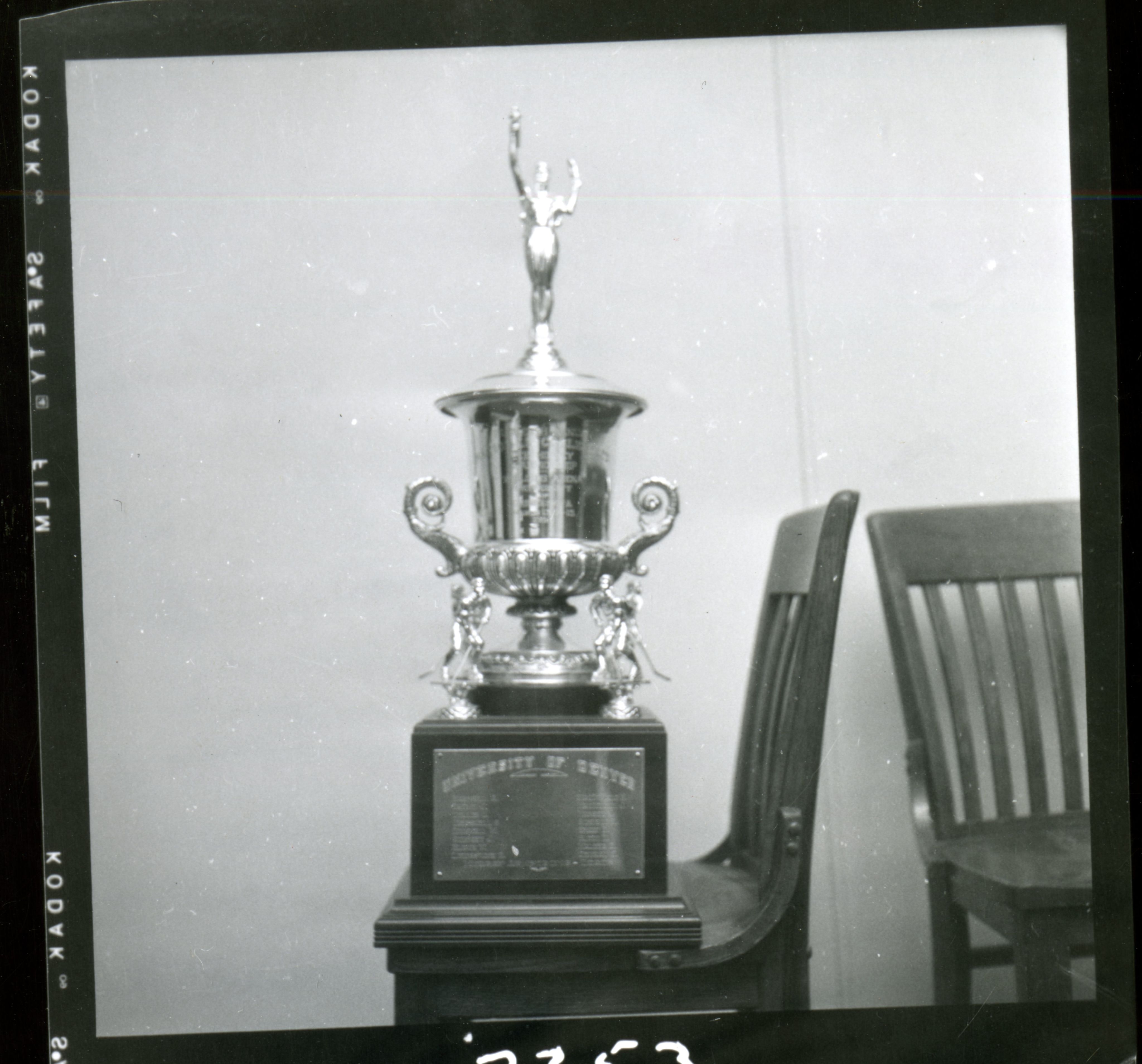 A black and white image of championship trophy placed on top of a chair.