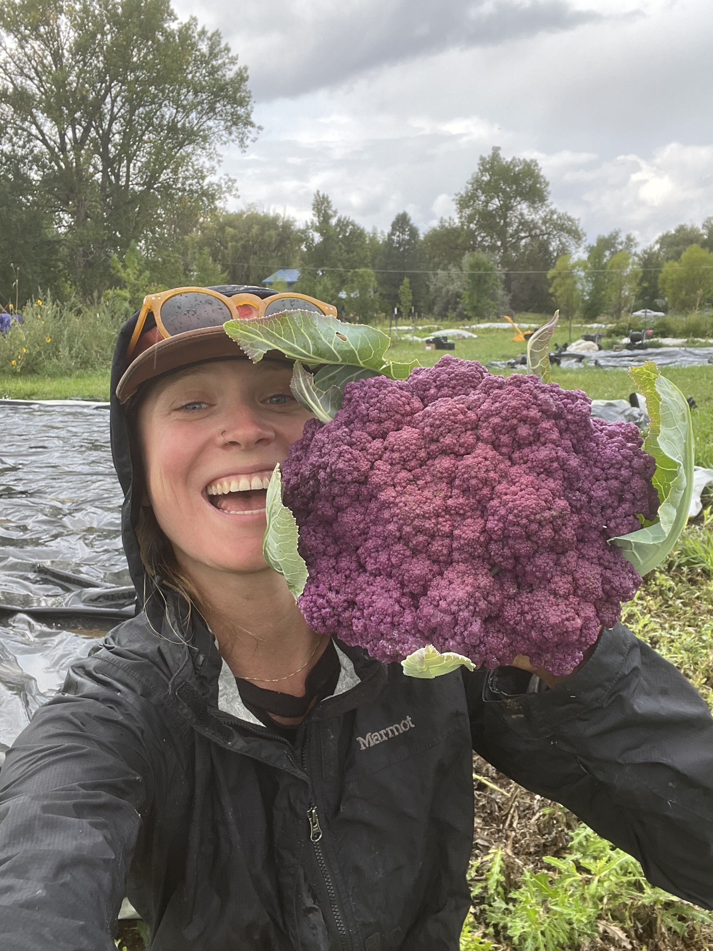 Katie Ketchum holding a vegetable on her farm
