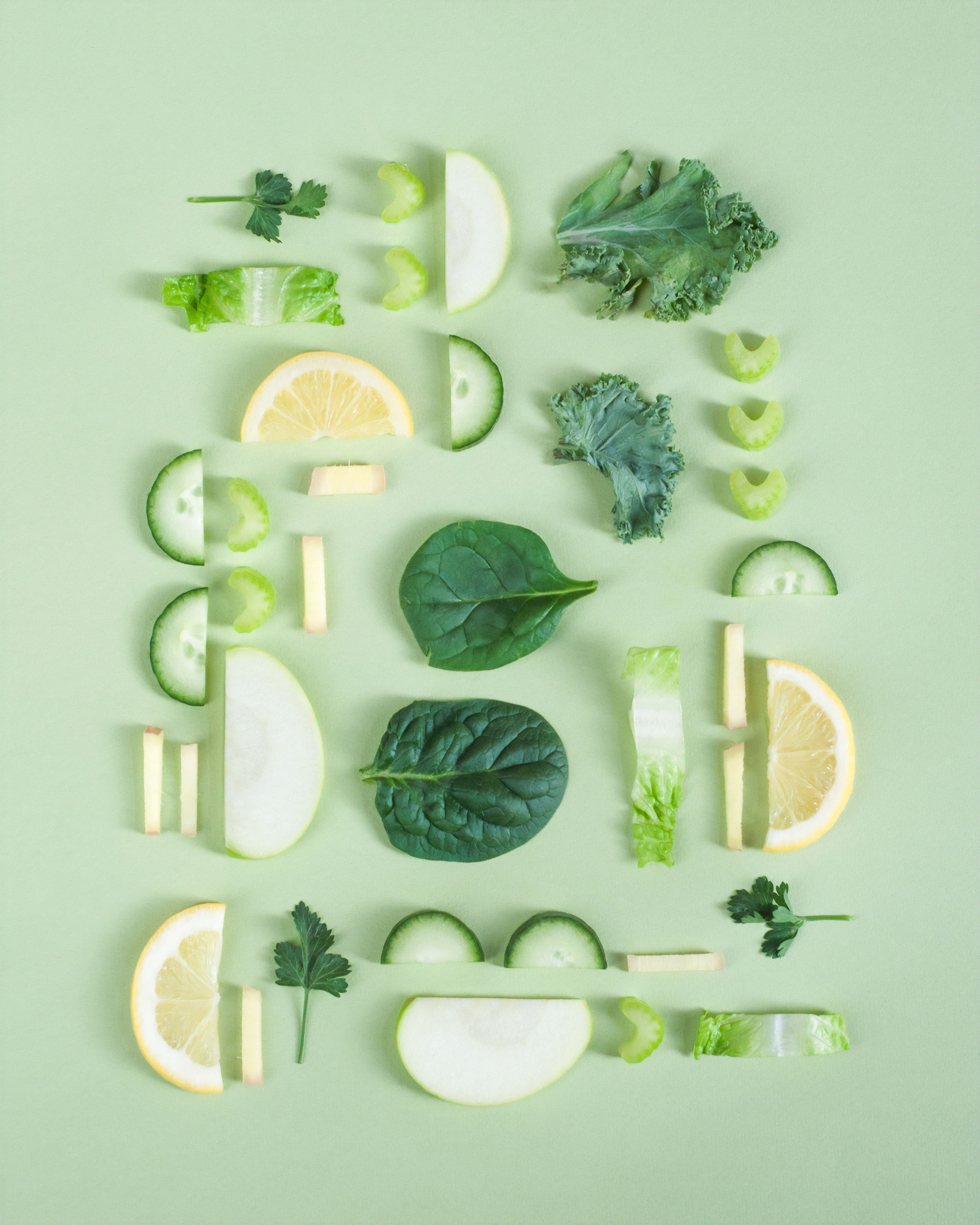 yellow and green sliced fruit and vegetables aligned symmetrically