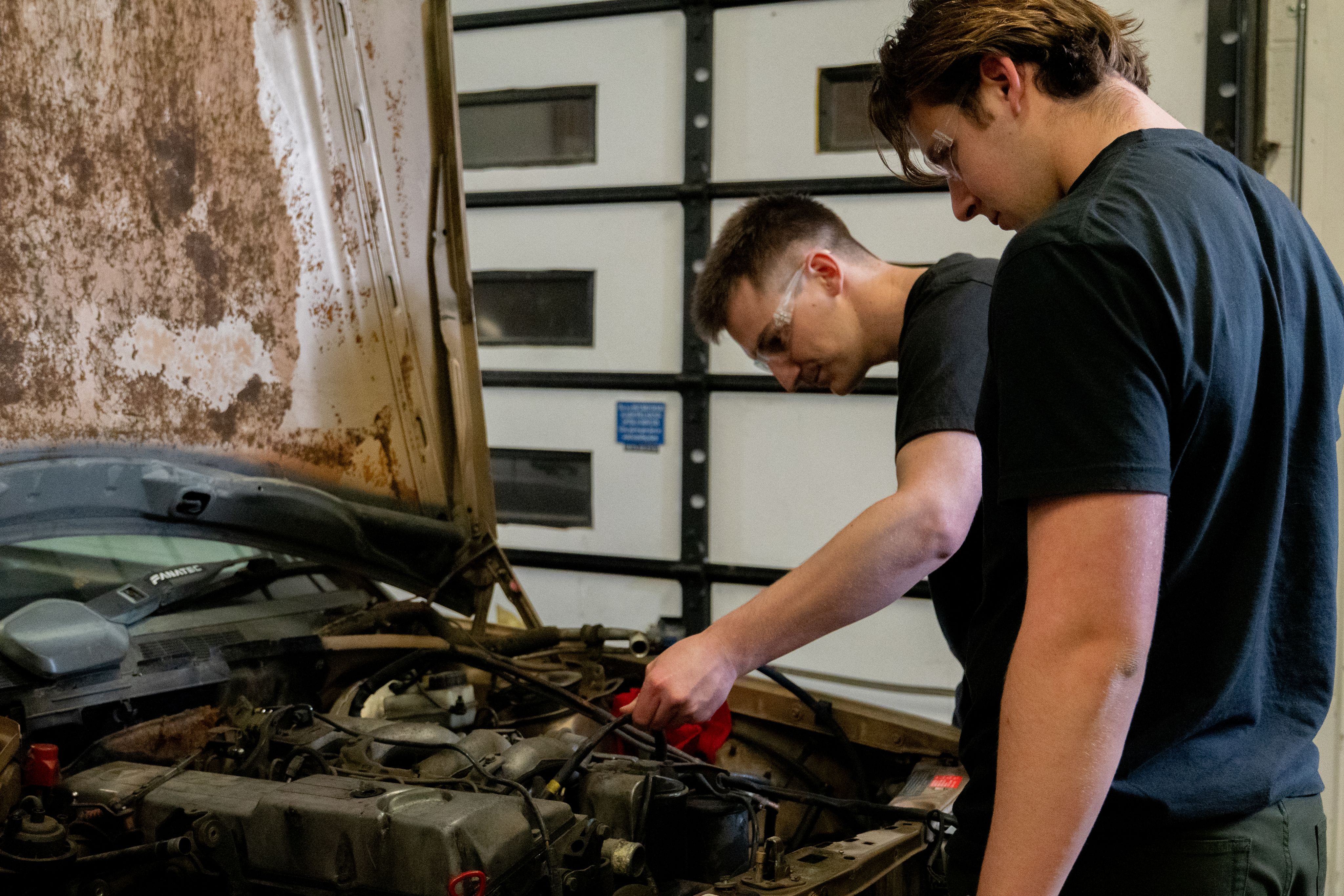 Remington and Carter working on the car