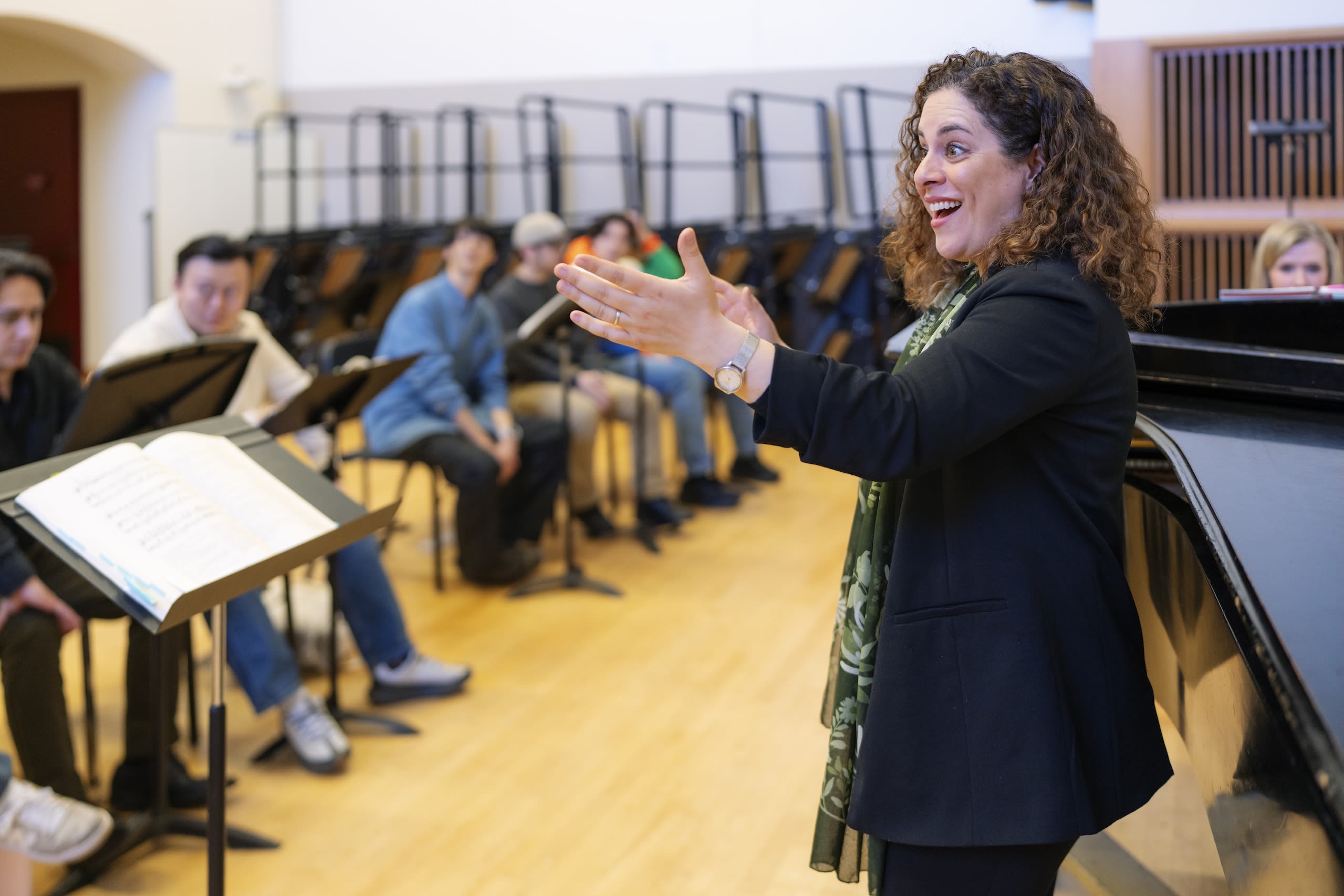 a person singing in front of a class