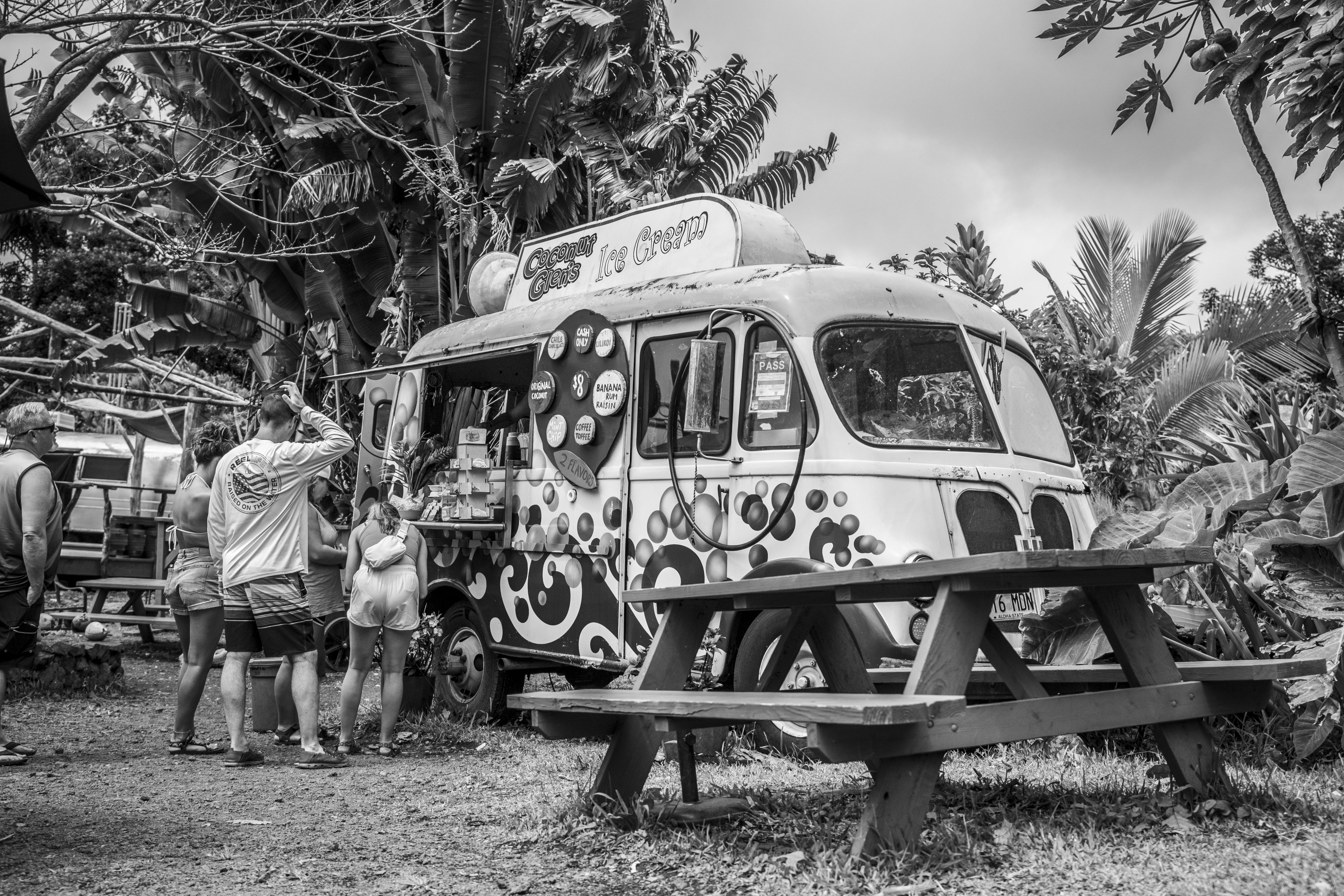 Tourists stand outside at a food van in Hawaii. 