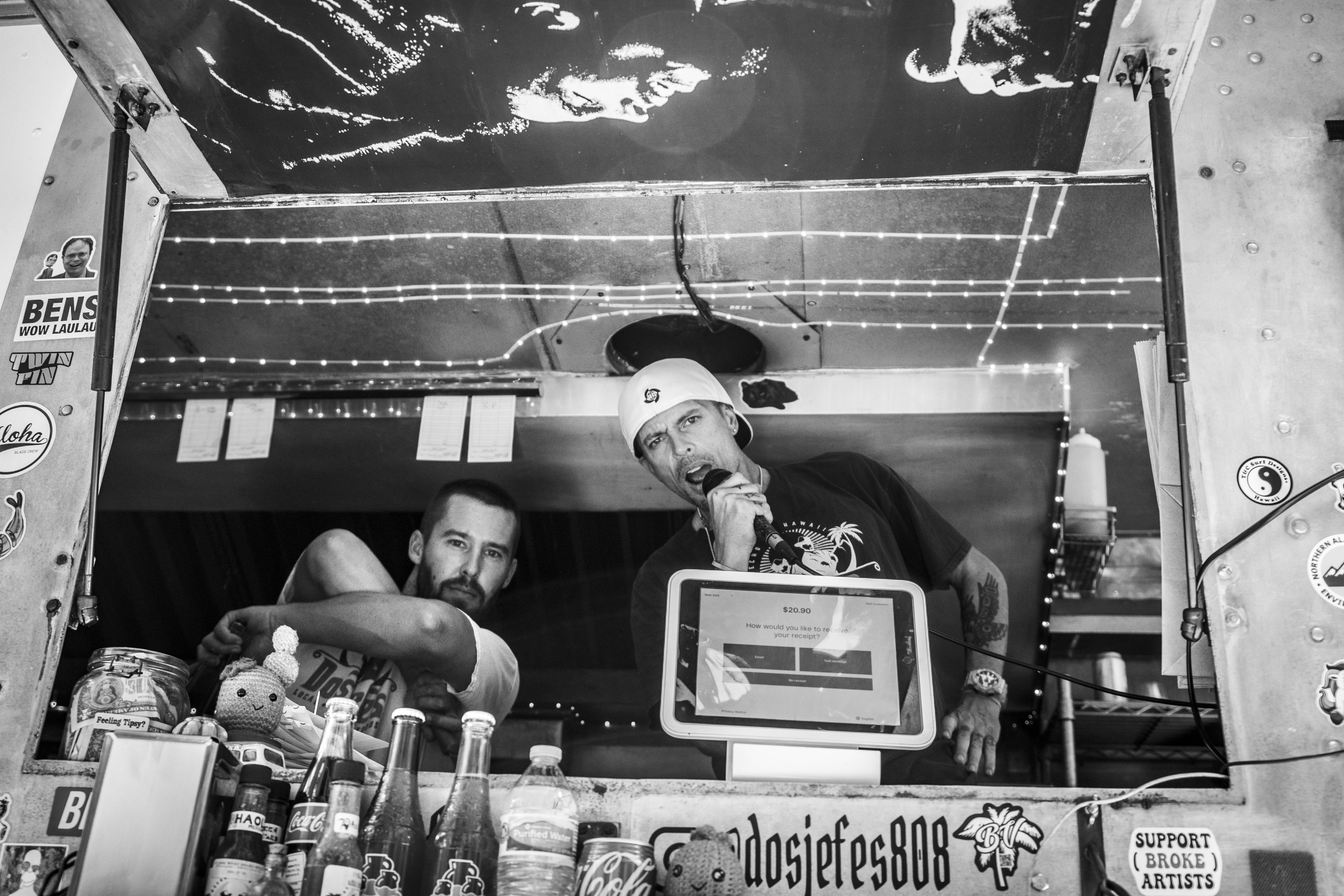 Two men in a food truck.
