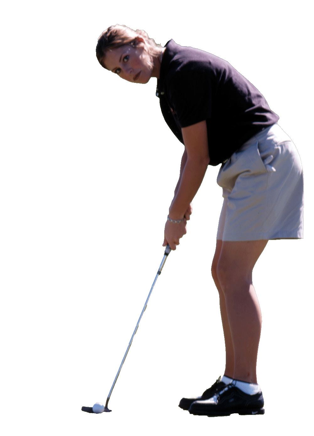 A golfer prepares to putt the ball. 