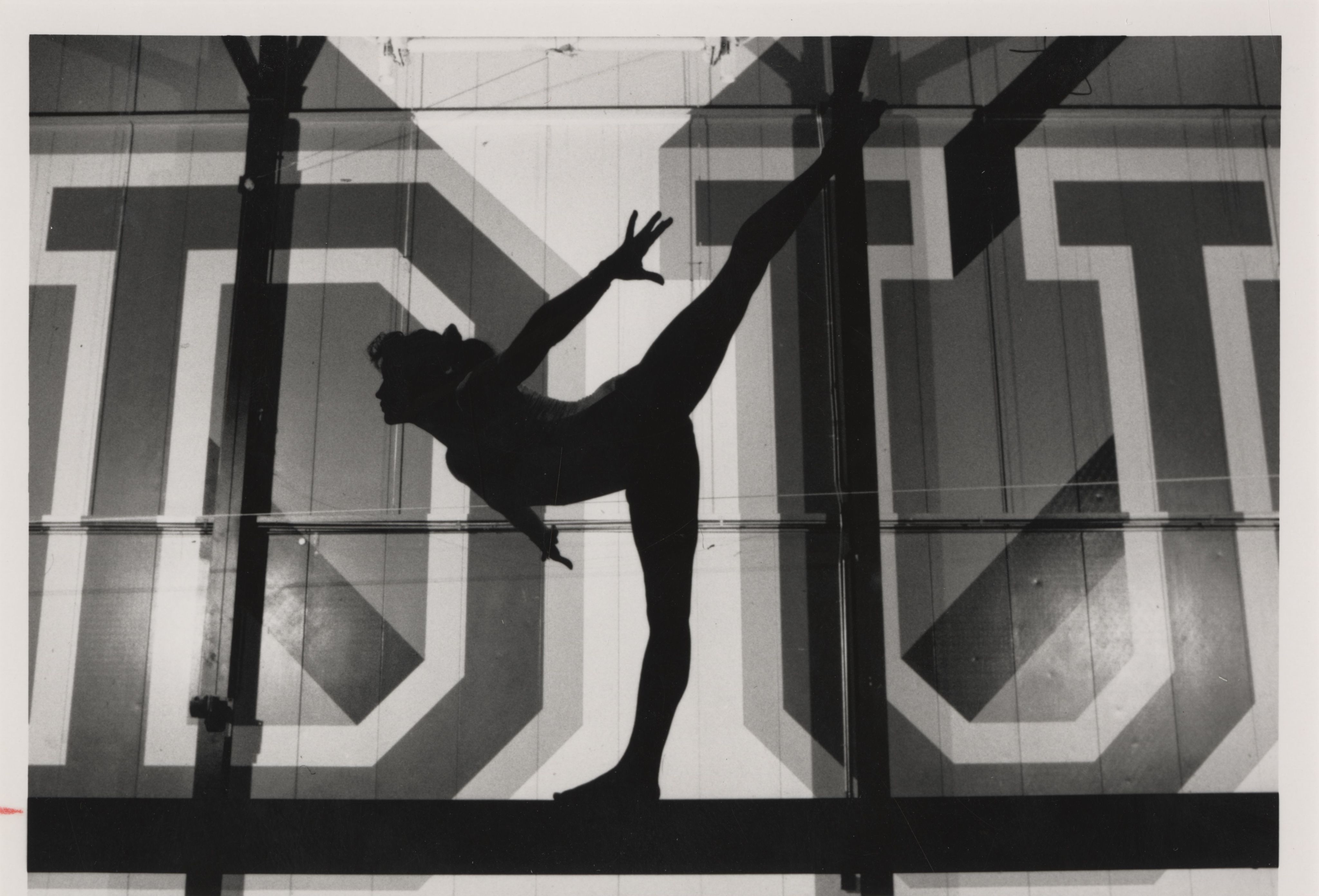 University of Denver (DU) Pioneers women's gymnastics team member performs an arabesque on a balance beam in the DU Field House Arena.