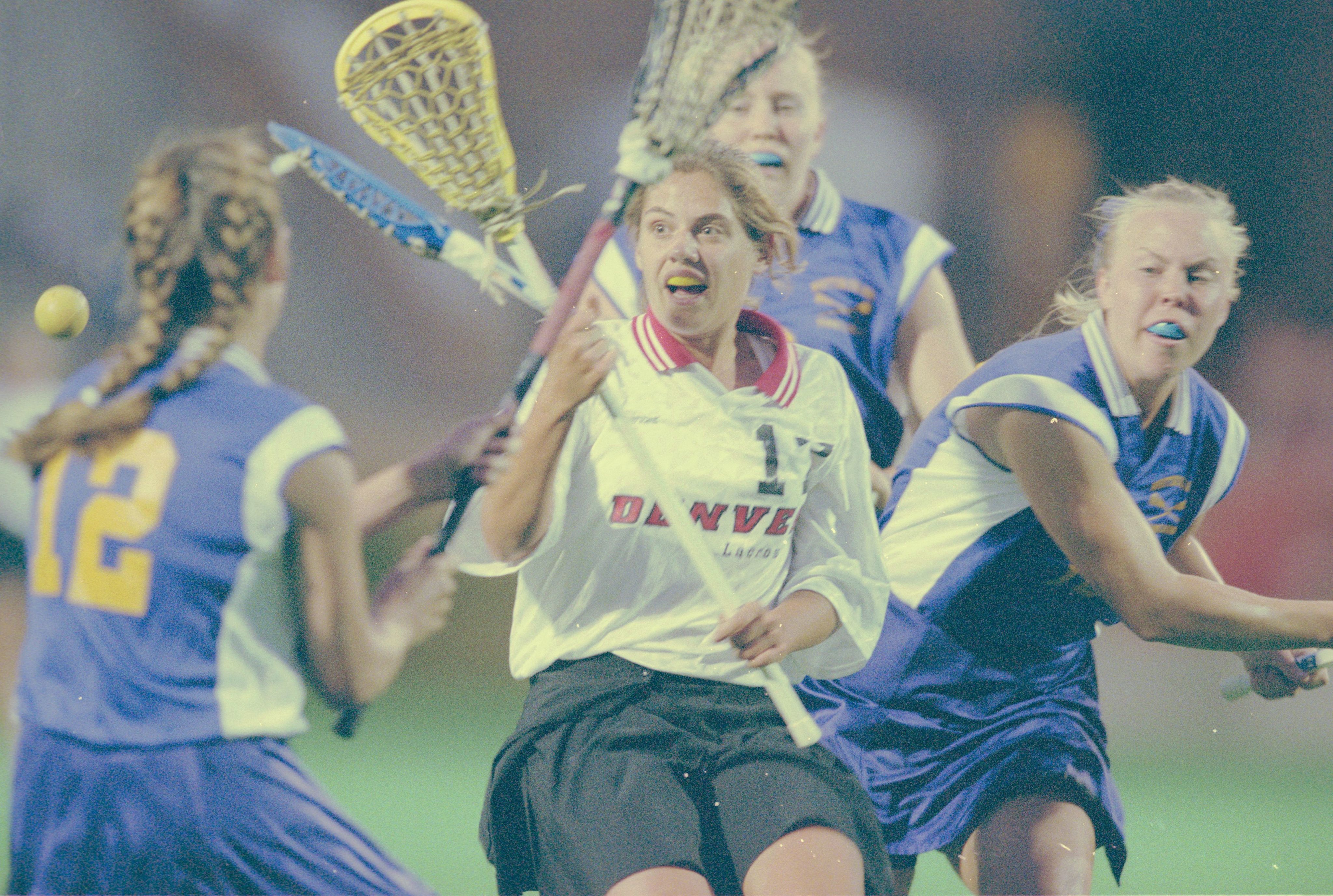 University of Denver (DU) Pioneers women's lacrosse player Erin Evans vies for control of the ball during a match against Whittier College.
