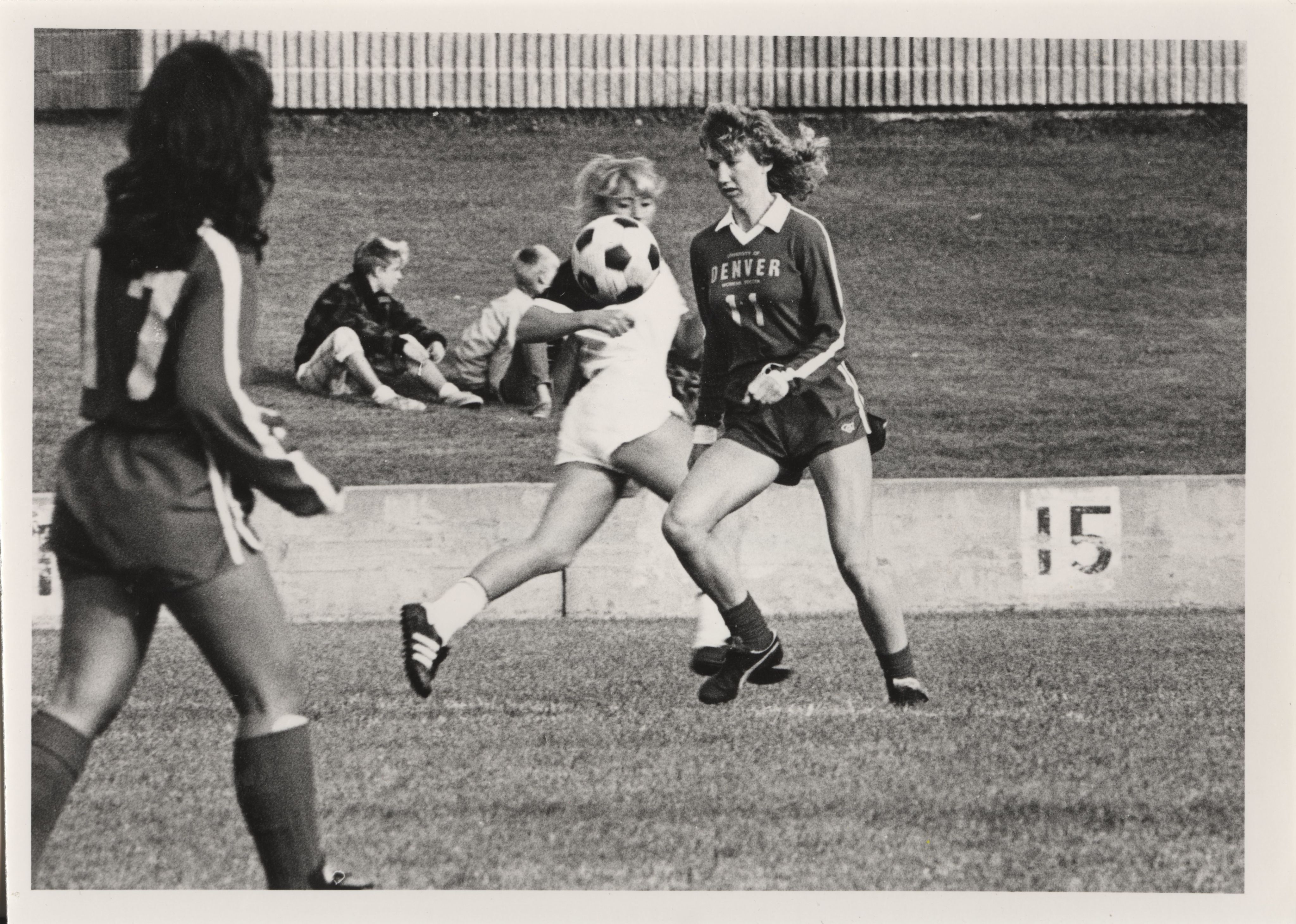 University of Denver (DU) Pioneers women's player (11) prepares to receive the ball during a match against Colorado College.