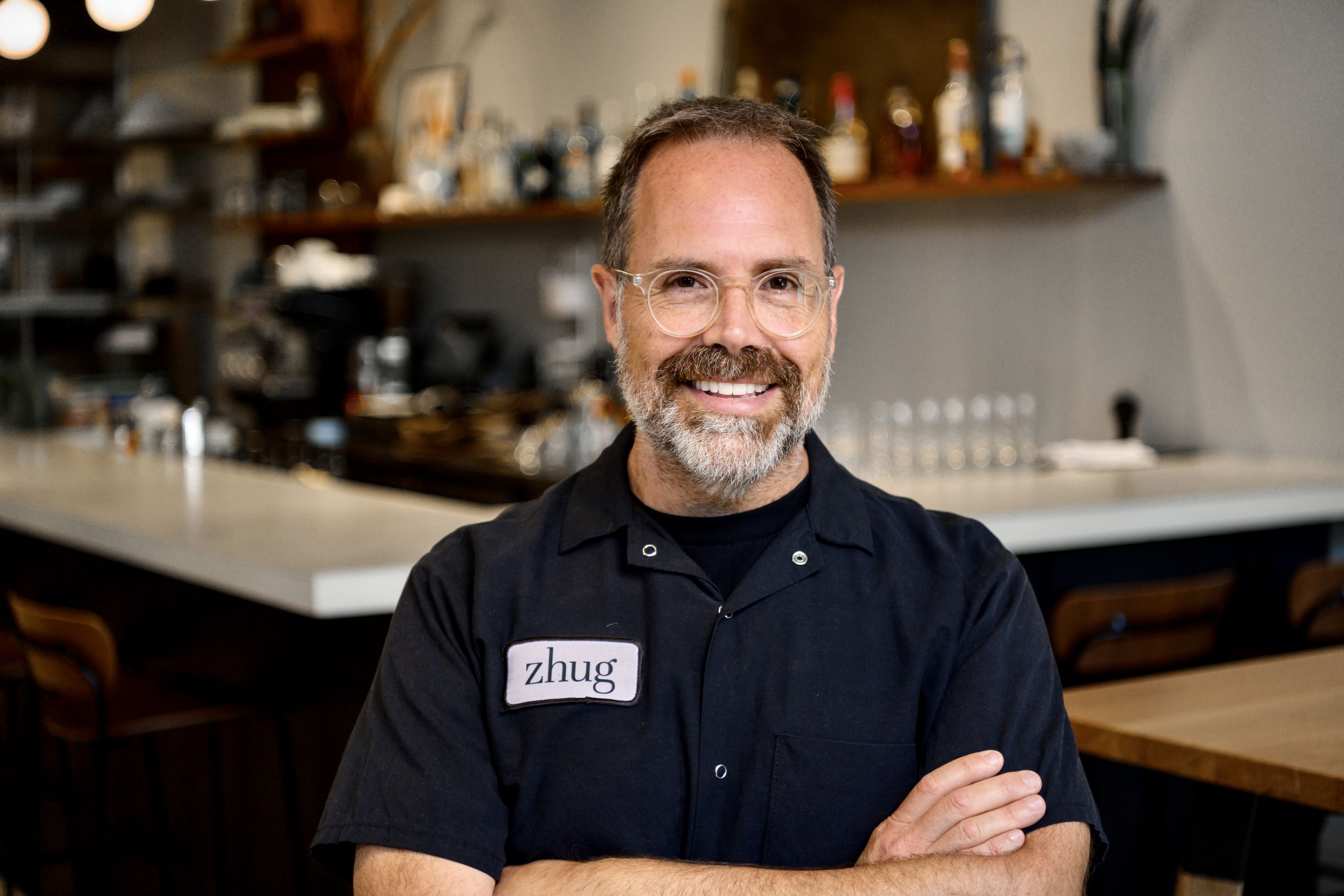 Alumnus Douglas Katz, with a bar at his restaurant visible in the background.