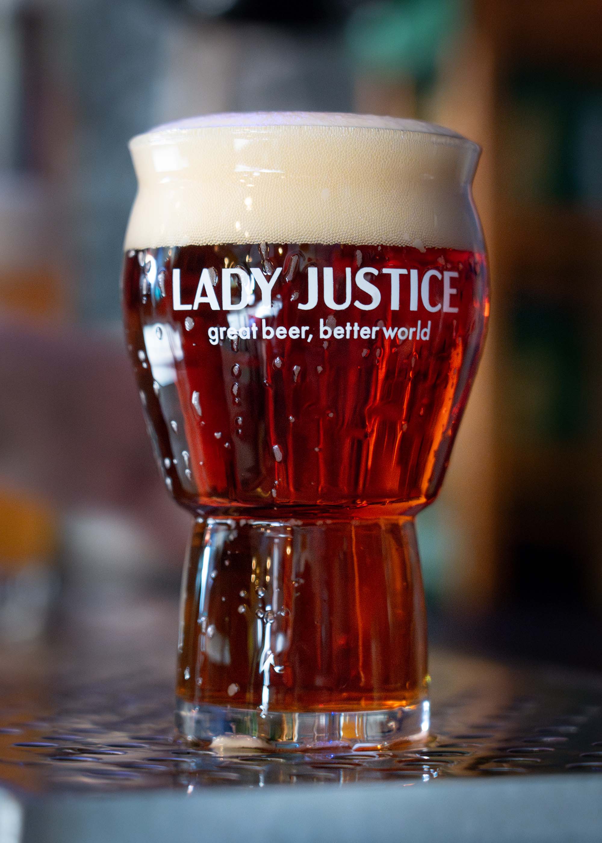 A beer glass with the Lady Justice logo.