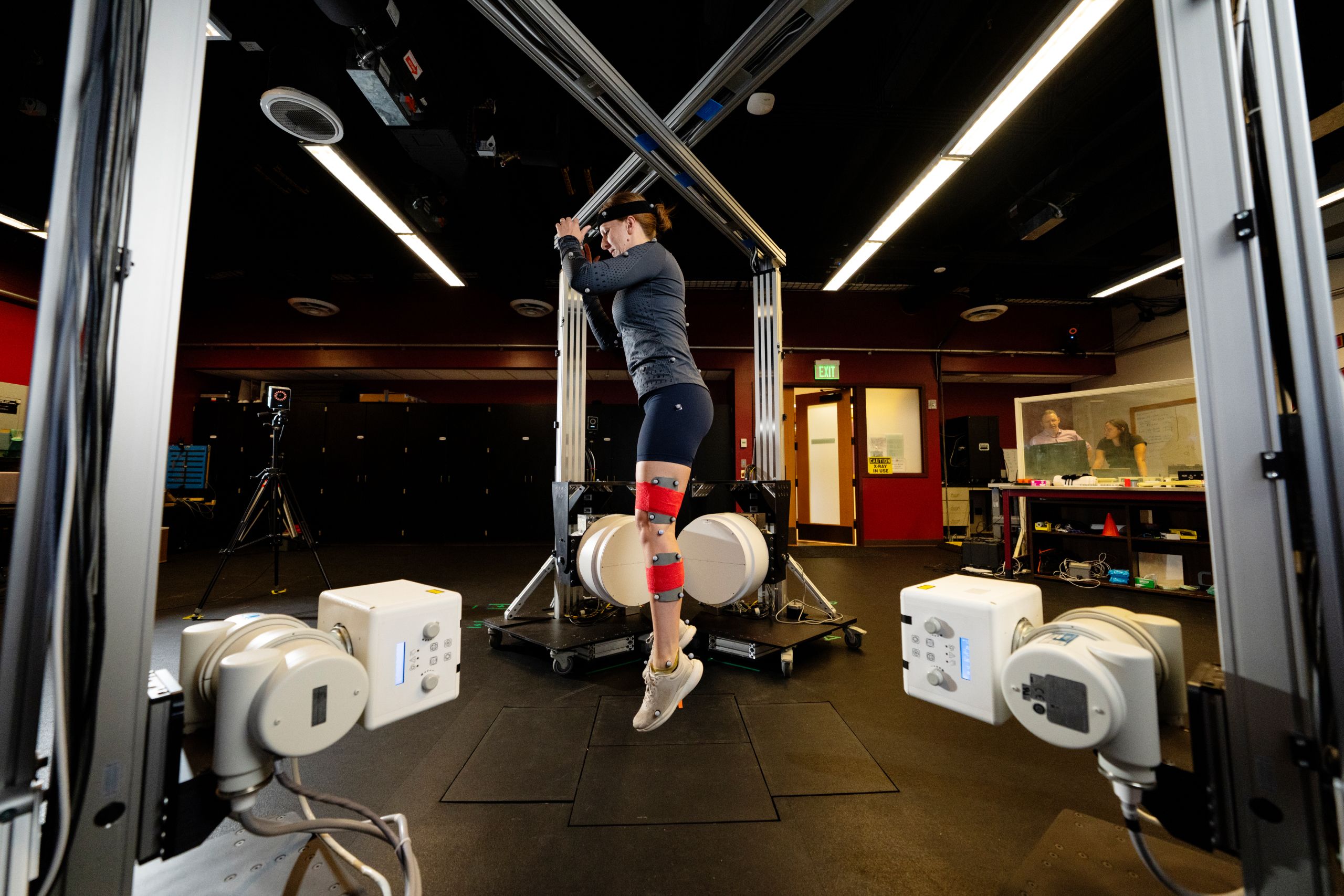 A woman wearing motion capture gear jumping