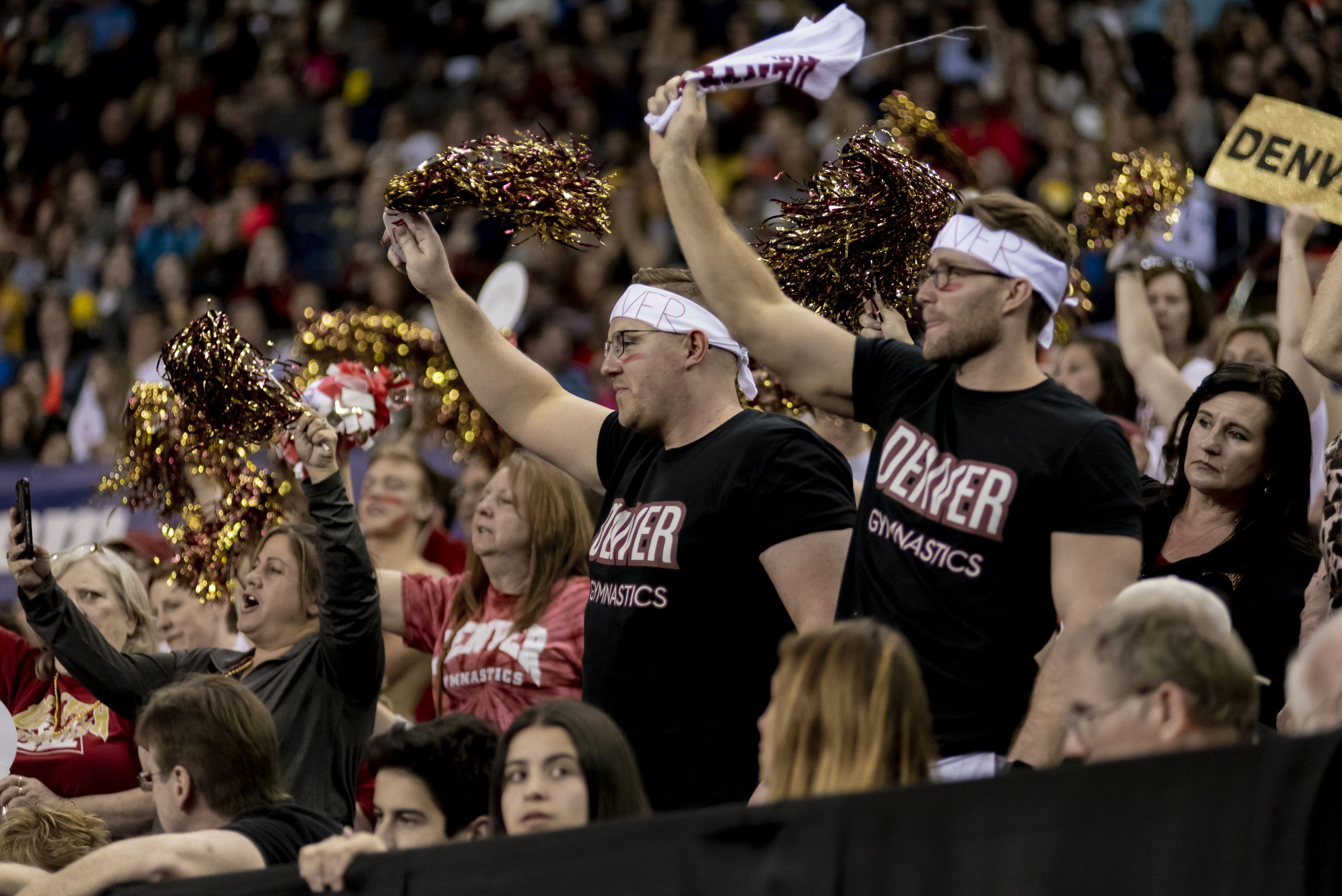 The Hype Men and other fans cheering in a packed crowd