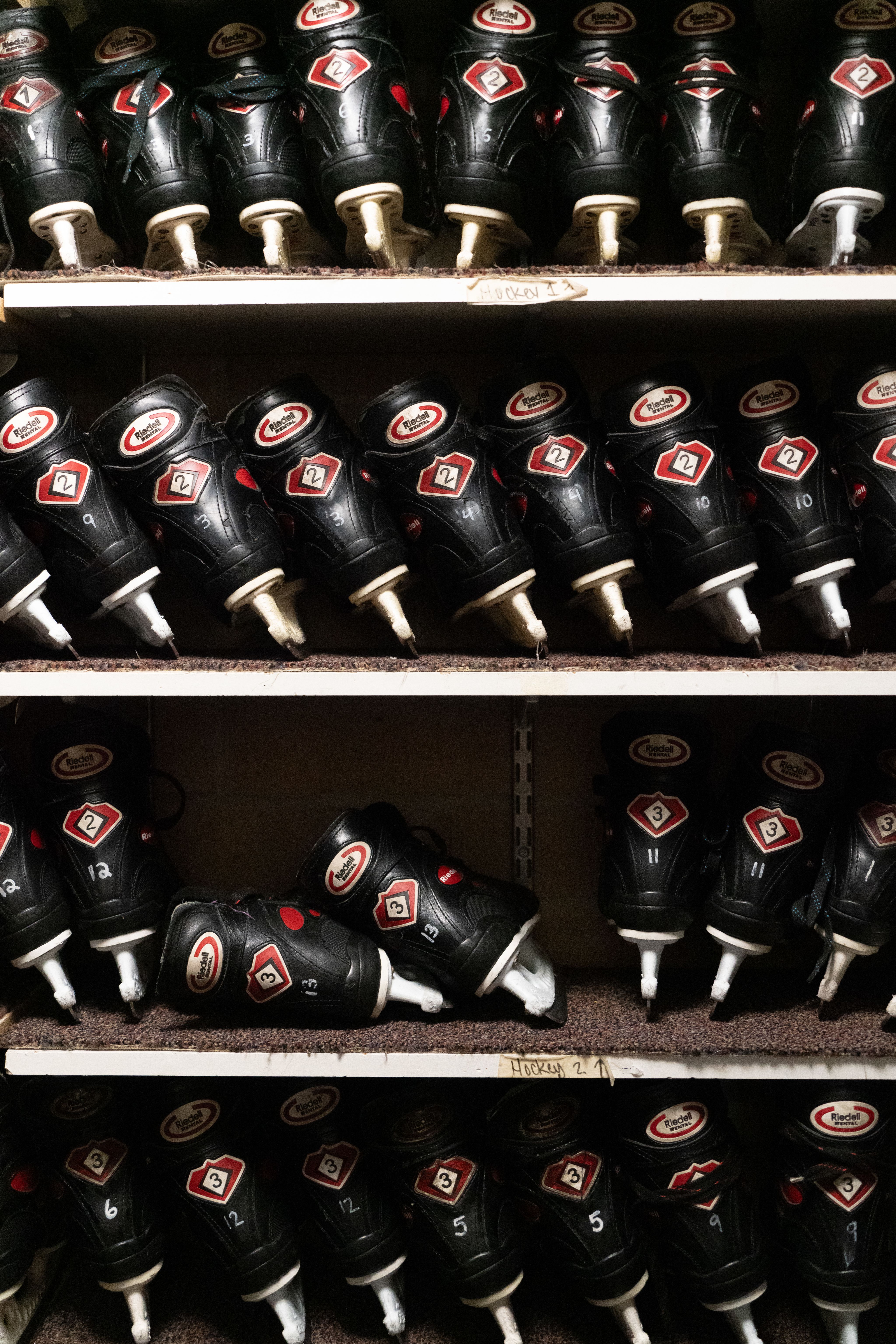 Ice skates stacked on shelves.