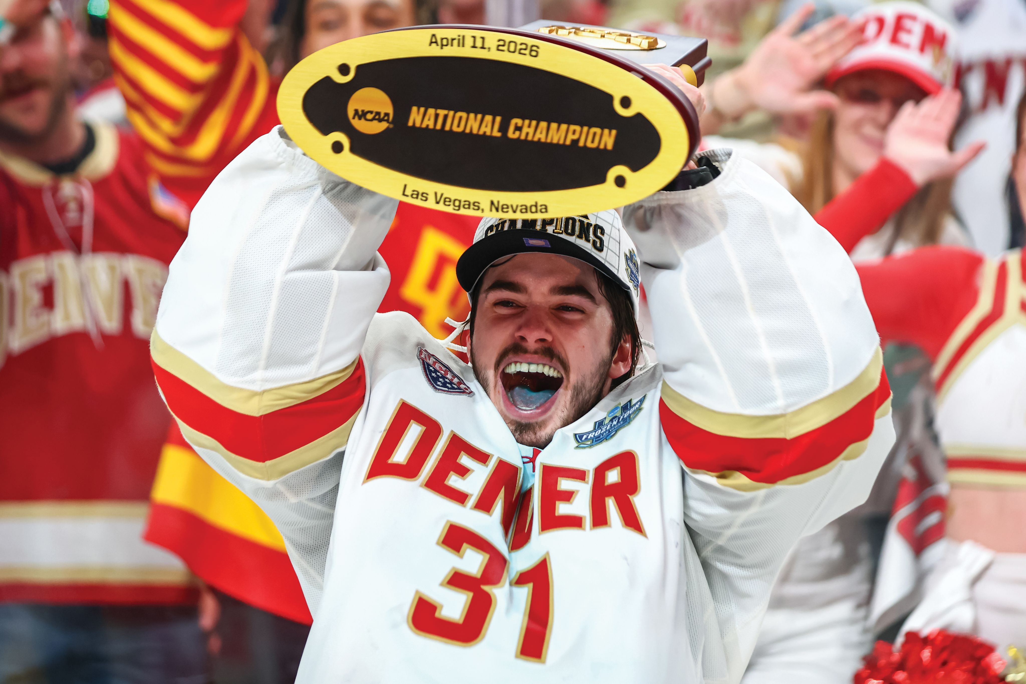 a hockey player holding up a trophy
