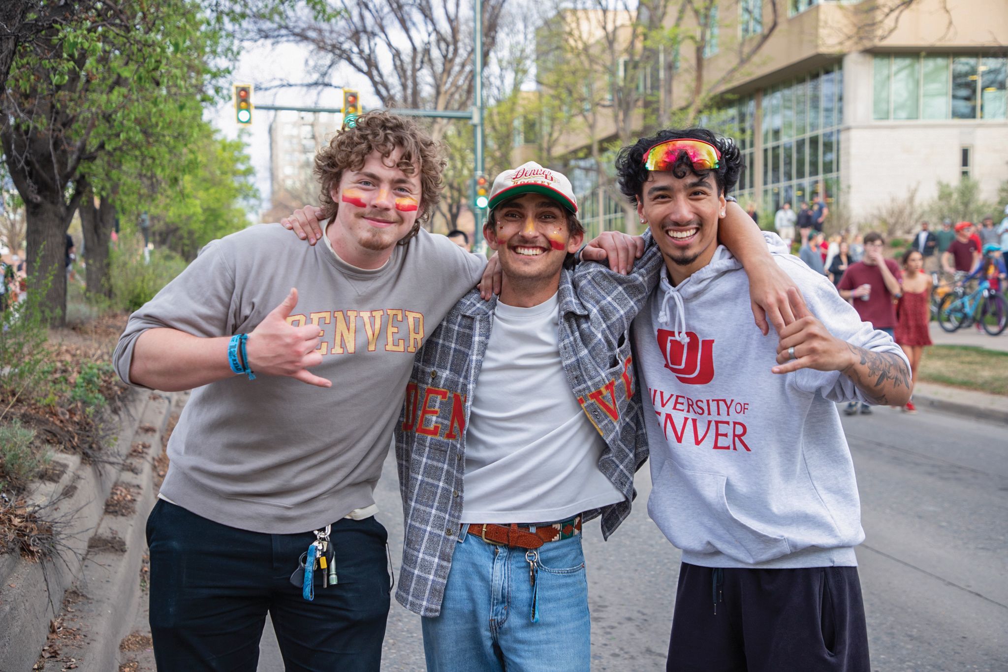 three students smiling in a street