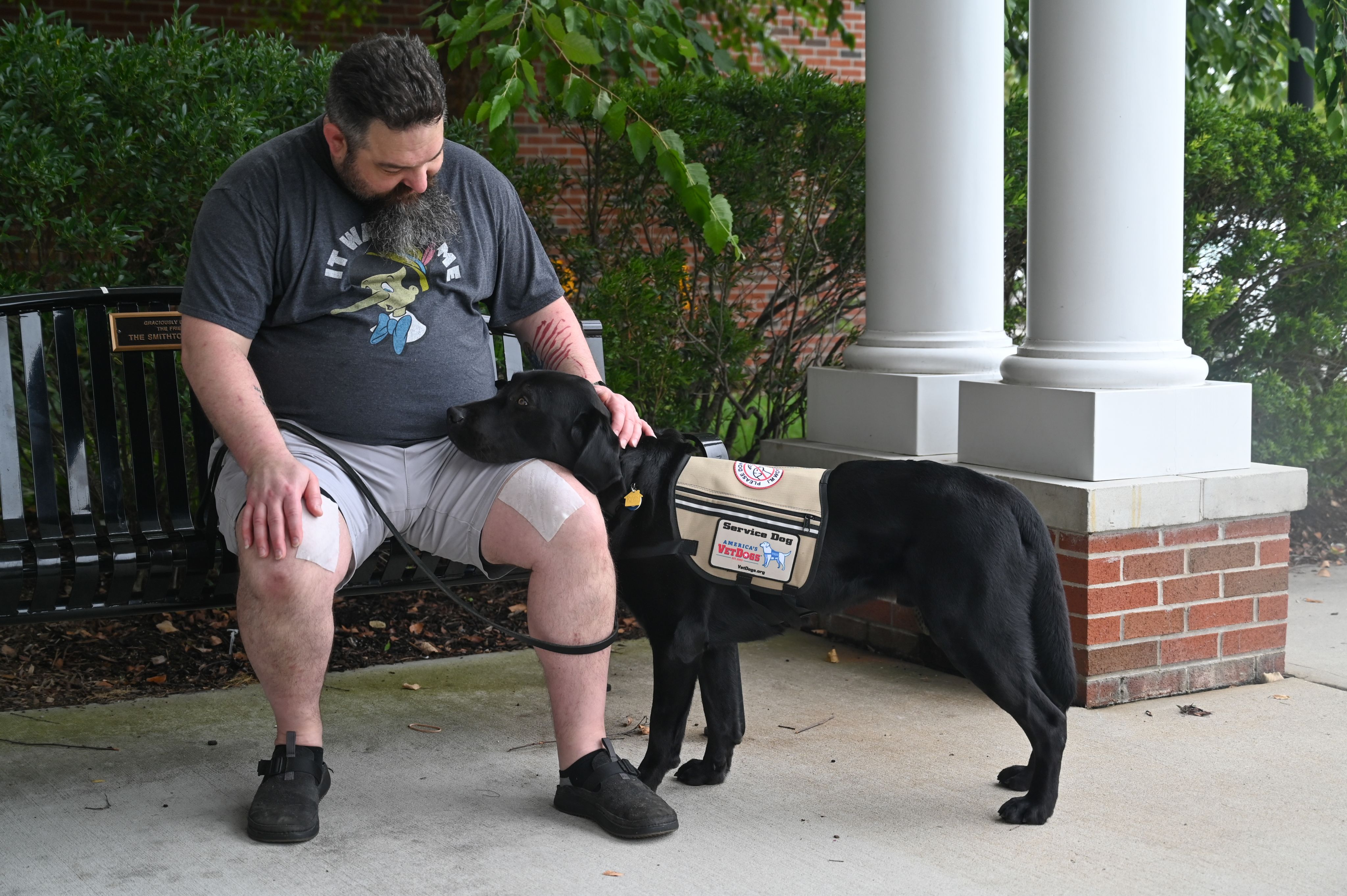 A man petting his service dog