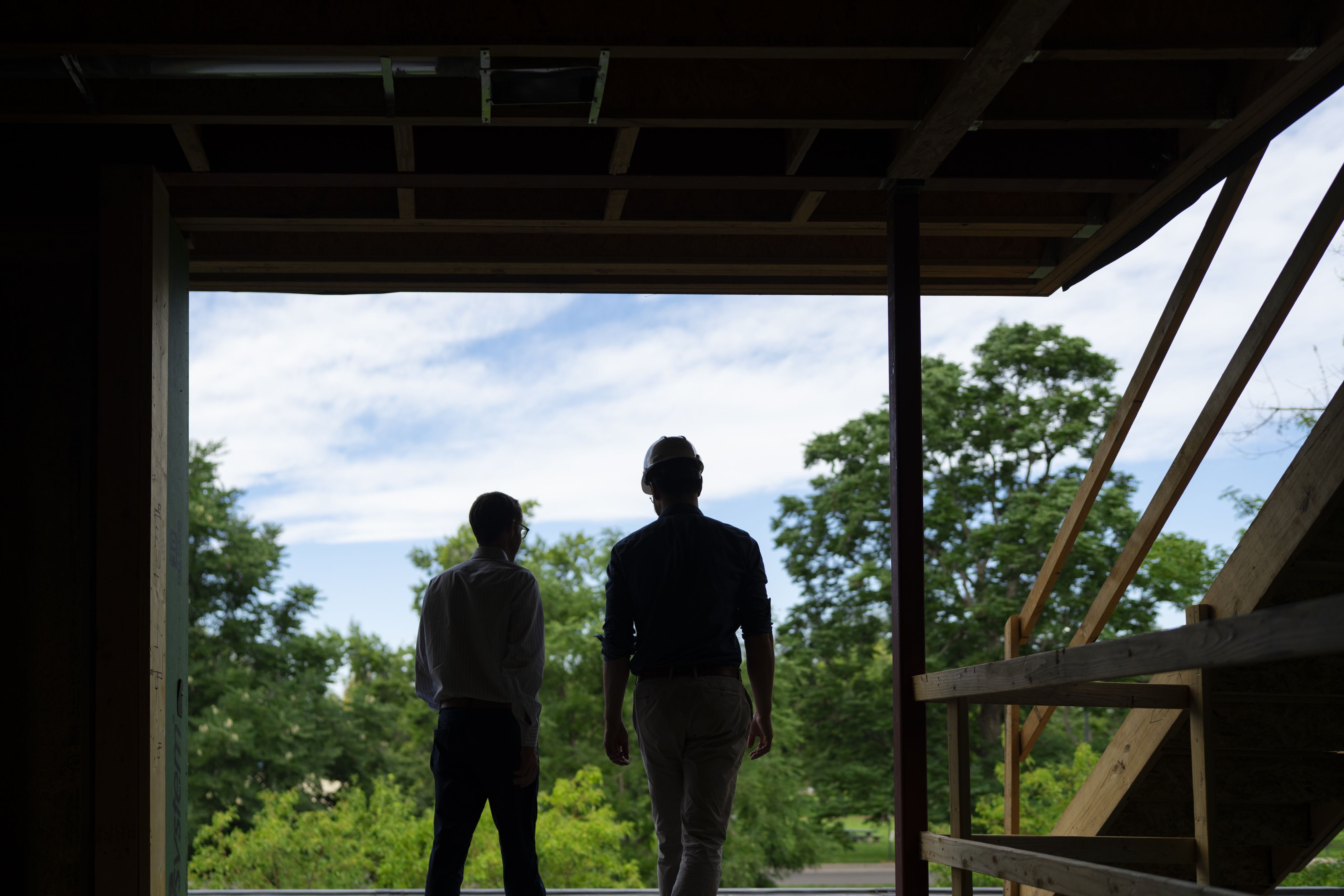 Two sillouettes in a constuction site.