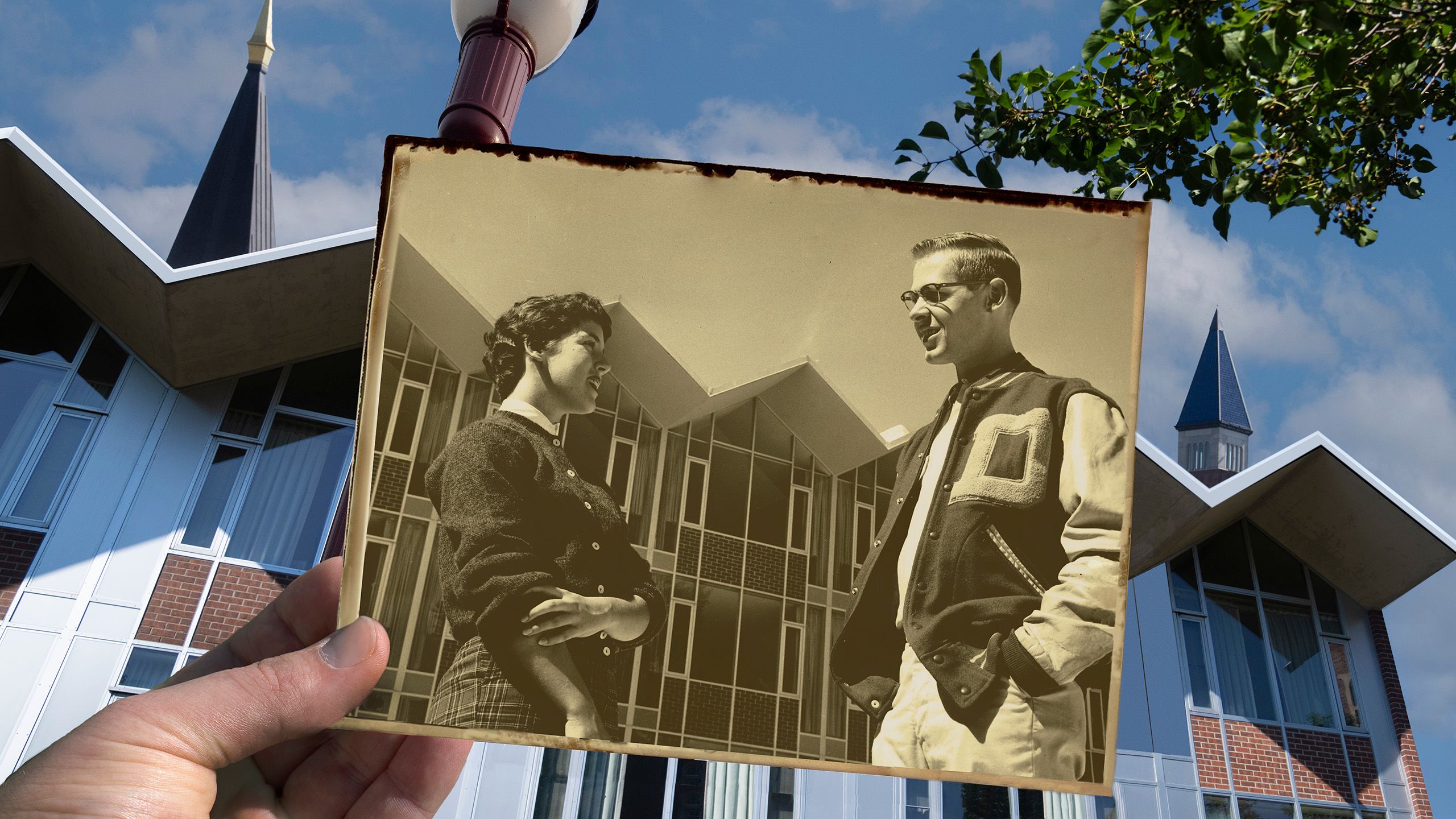 Composite image of historic photo of two students standing in front of JMAC dorm, with the modern building in the background.