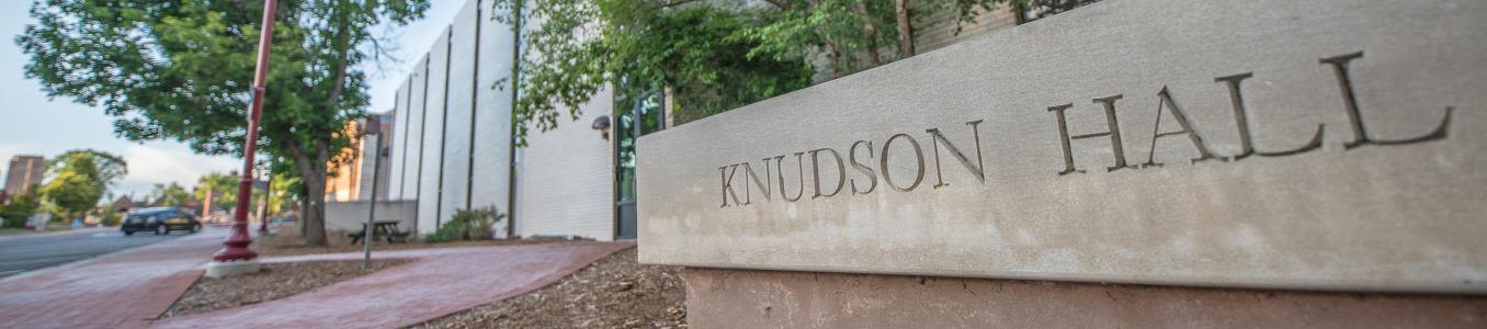 A photo of the stone sign outside of Knudson Hall