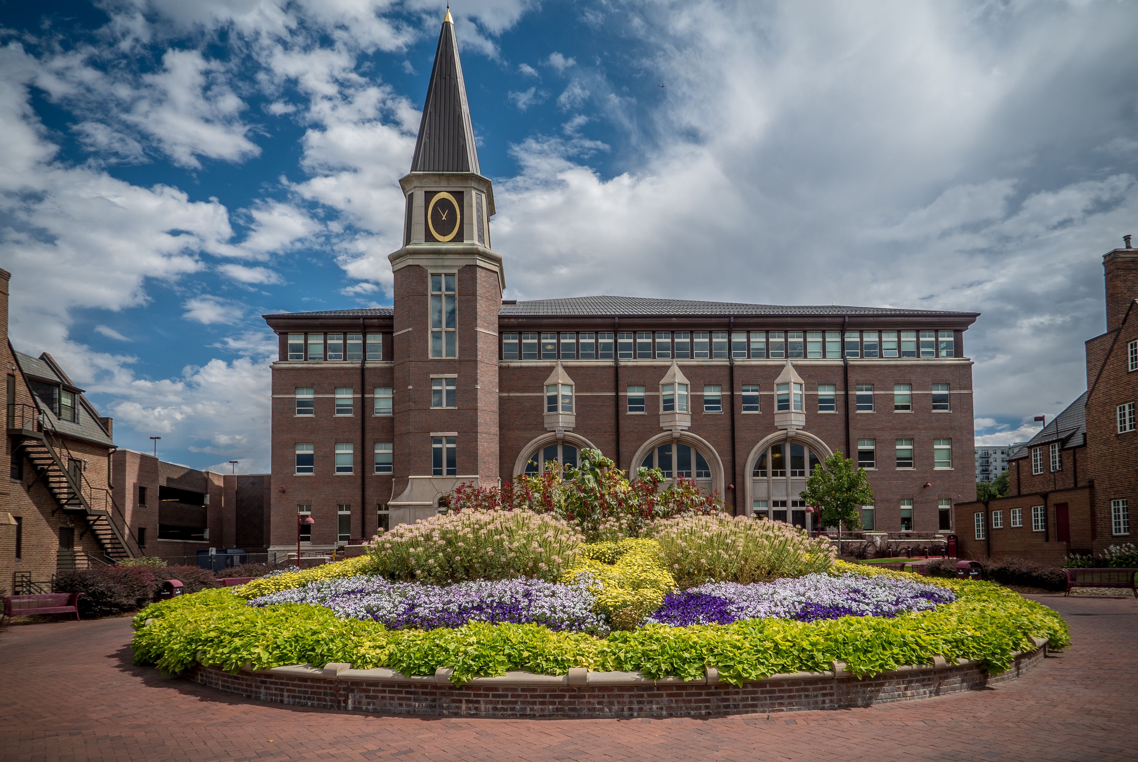 An exterior photo of the Ricketson Law Building, with flowers visible in the foreground