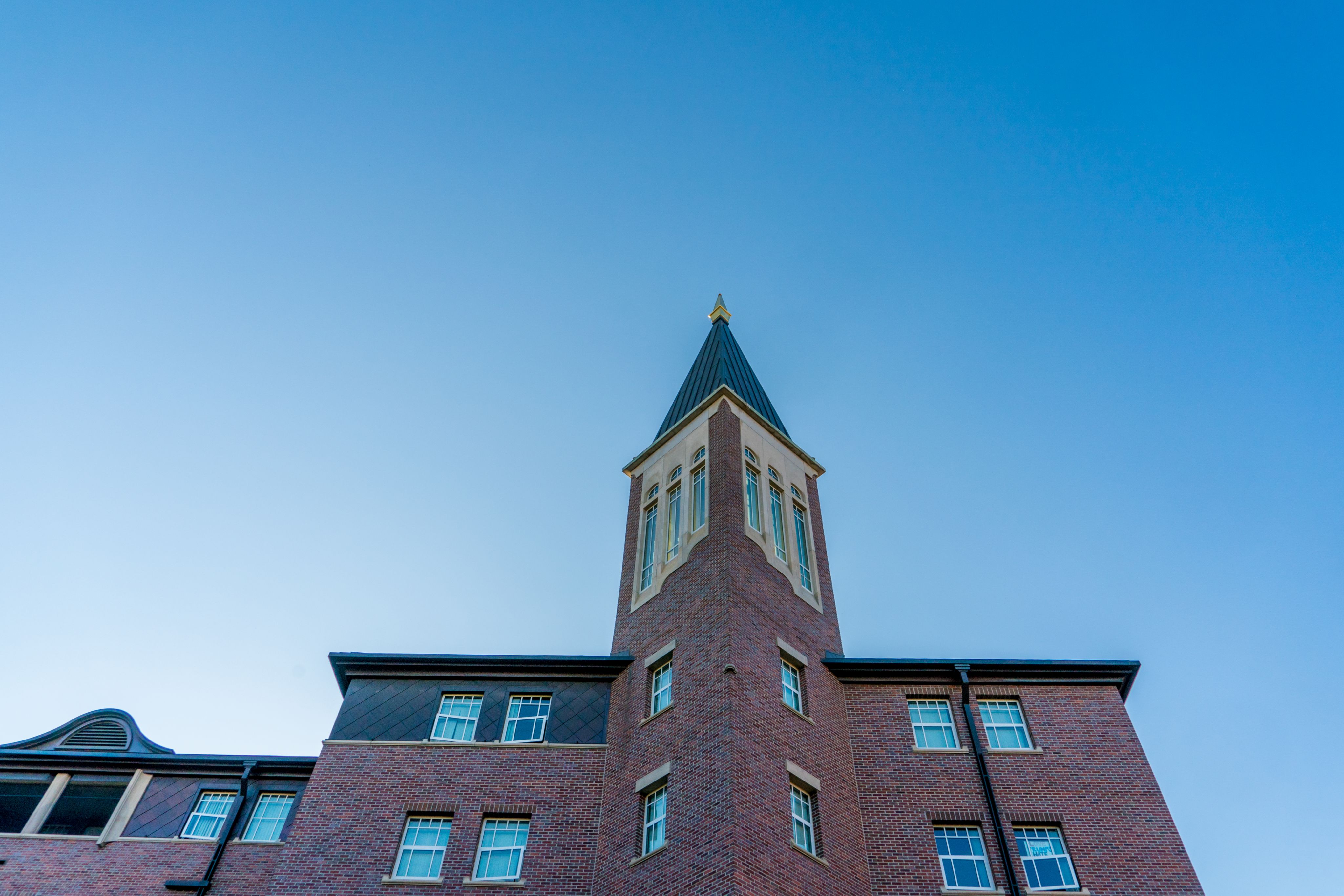 An exterior shot of Nelson Hall with blue sky in the background