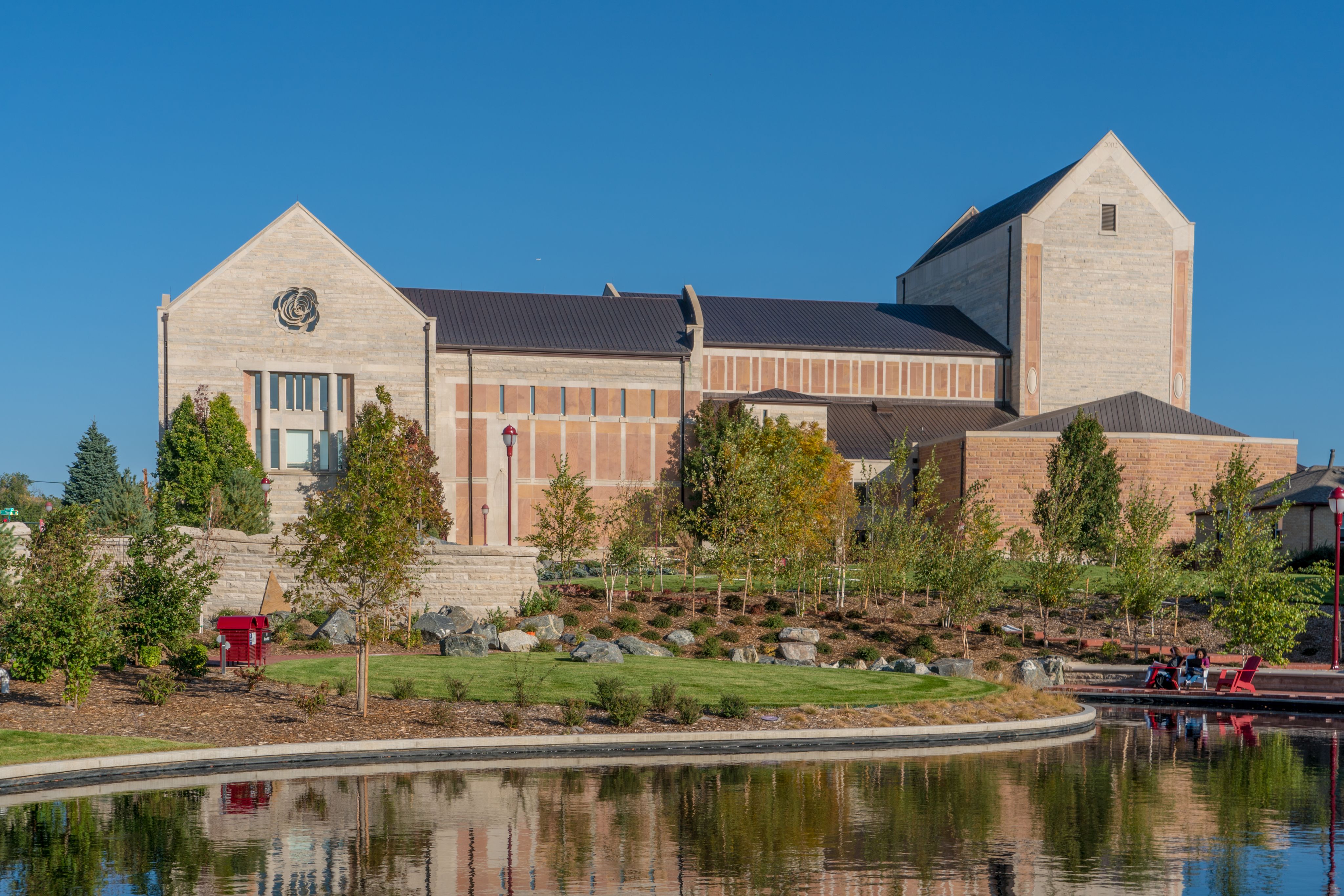 An exterior shot of the Newman Center, with Dan's Garden visible in the foreground