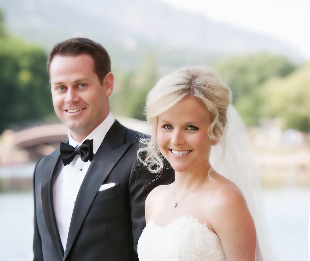 Adam and Jennifer on their wedding day in a black suit and wedding dress.