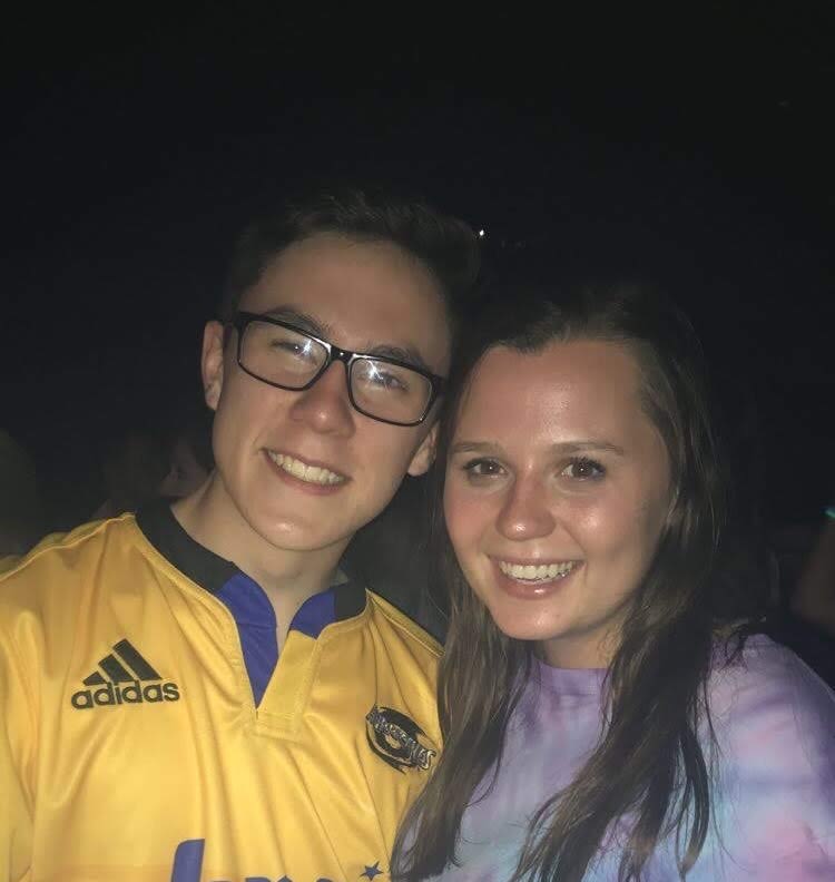 Elizabeth and Cameron stand together.