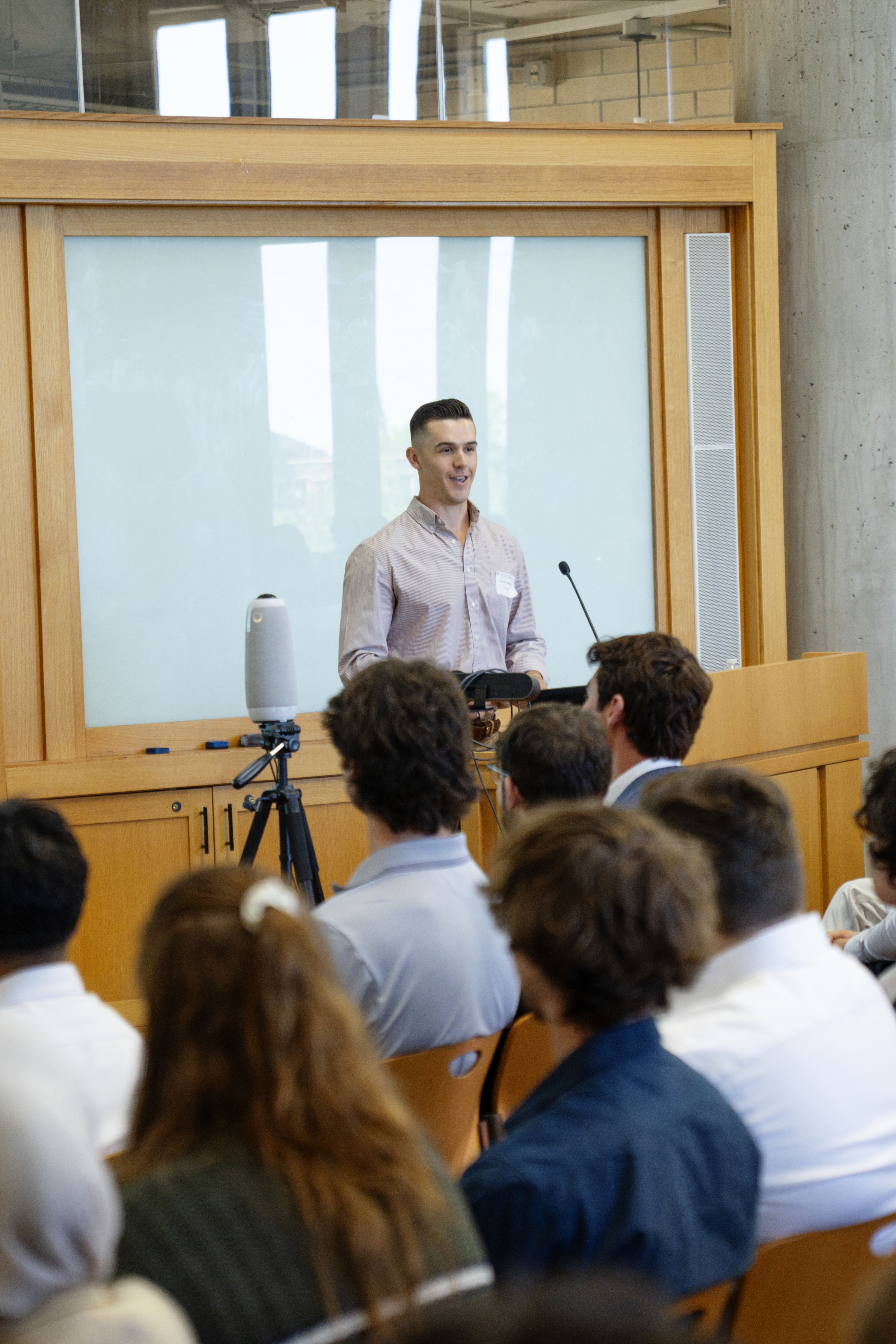Senior Gunnar Johnson presents the prototype device to peers and industry partners at the 2025 Senior Design Symposium.