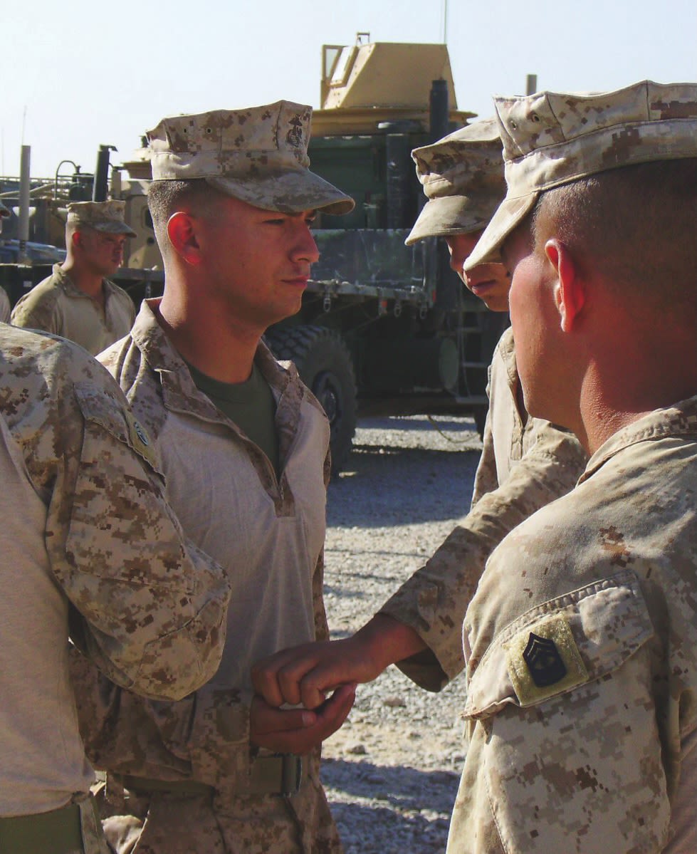 an image of soldiers in fatigues standing in a circle