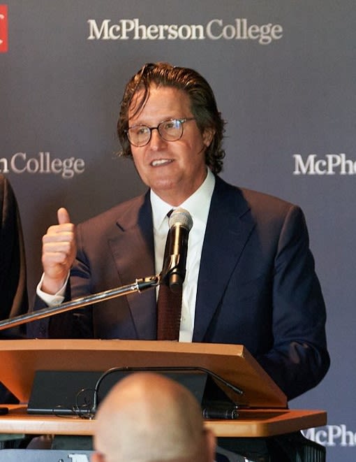 Mike Schneider speaking into a microphone