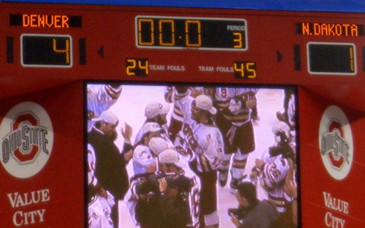 A photo of a scoreboard showing the Denver Pioneer's victory over North Dakota