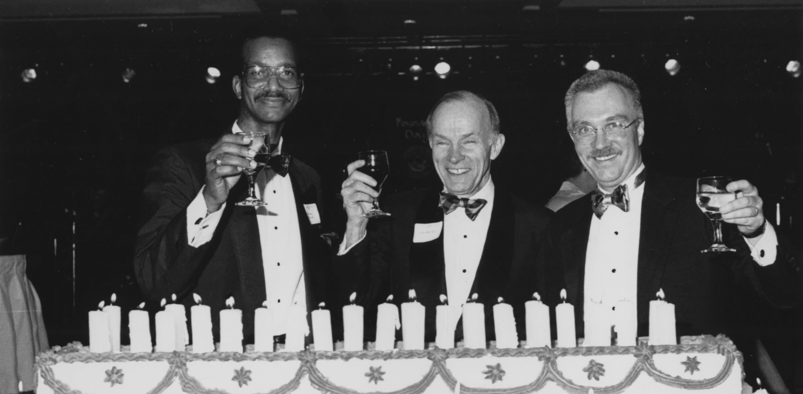 Dan Ritchie and two men in tuxedos at a celebration