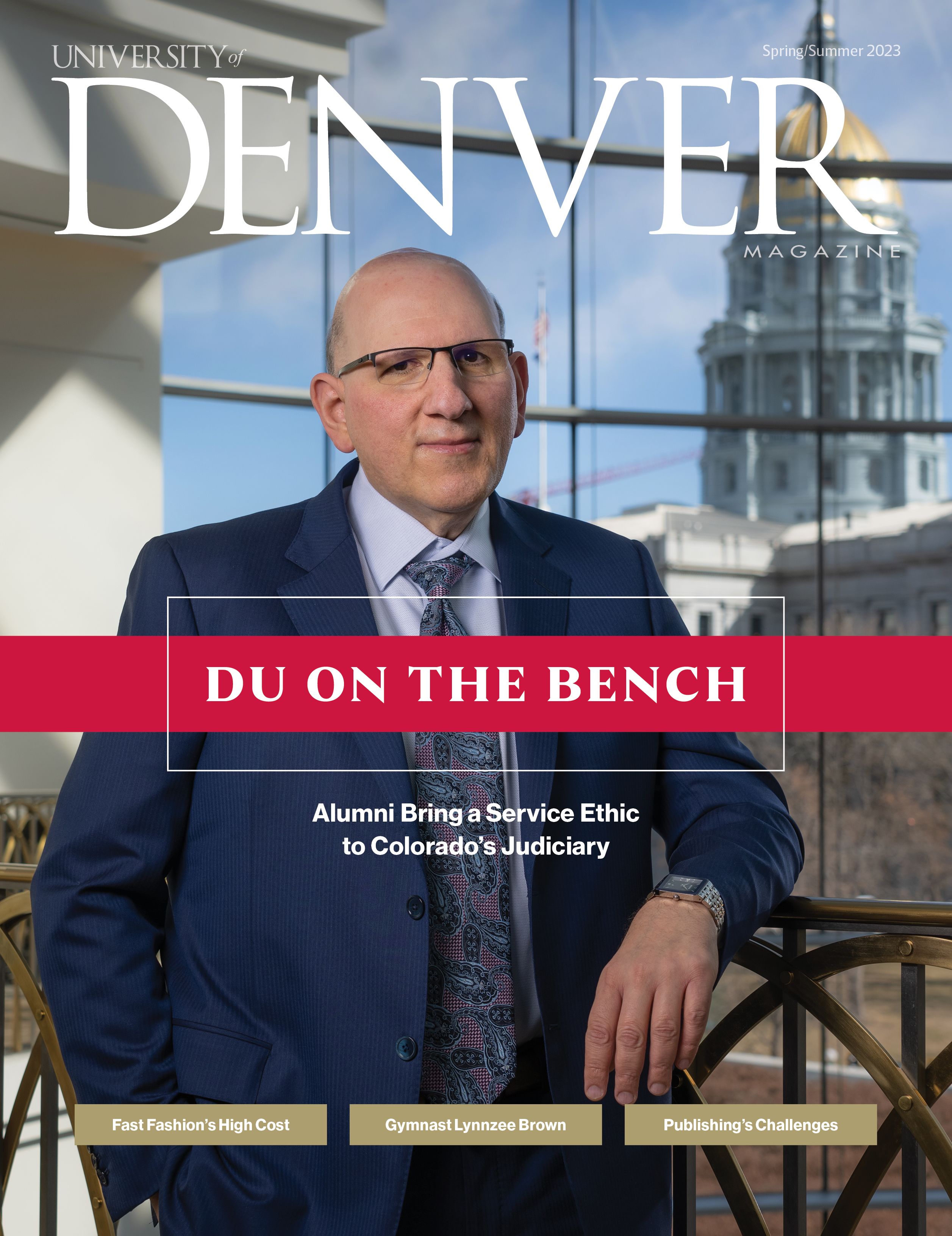 DU magazine cover with words "DU on the bend" below the photo of a judge in front of a window with the Denver capital outside 