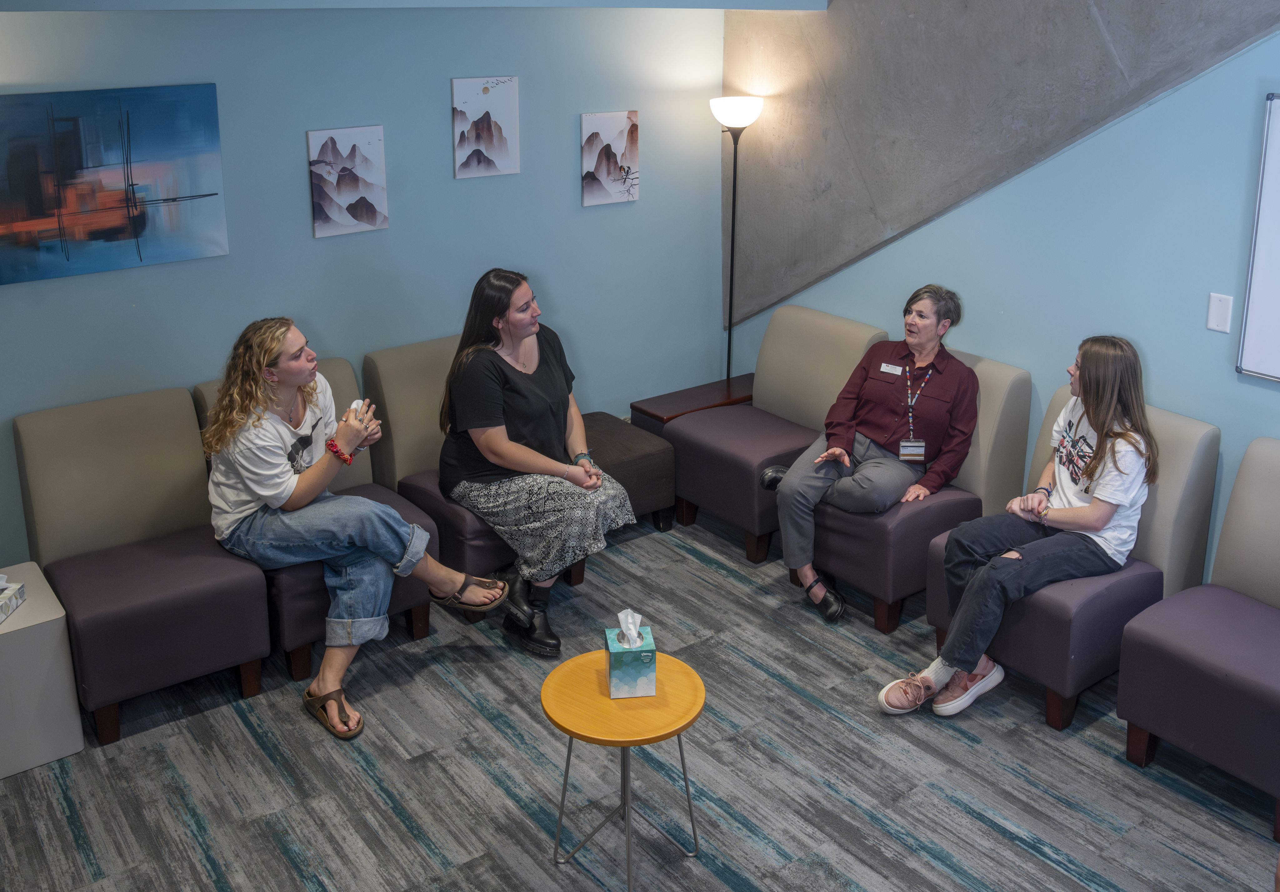 DU staff and students sit in the reception area of the health and counseling center