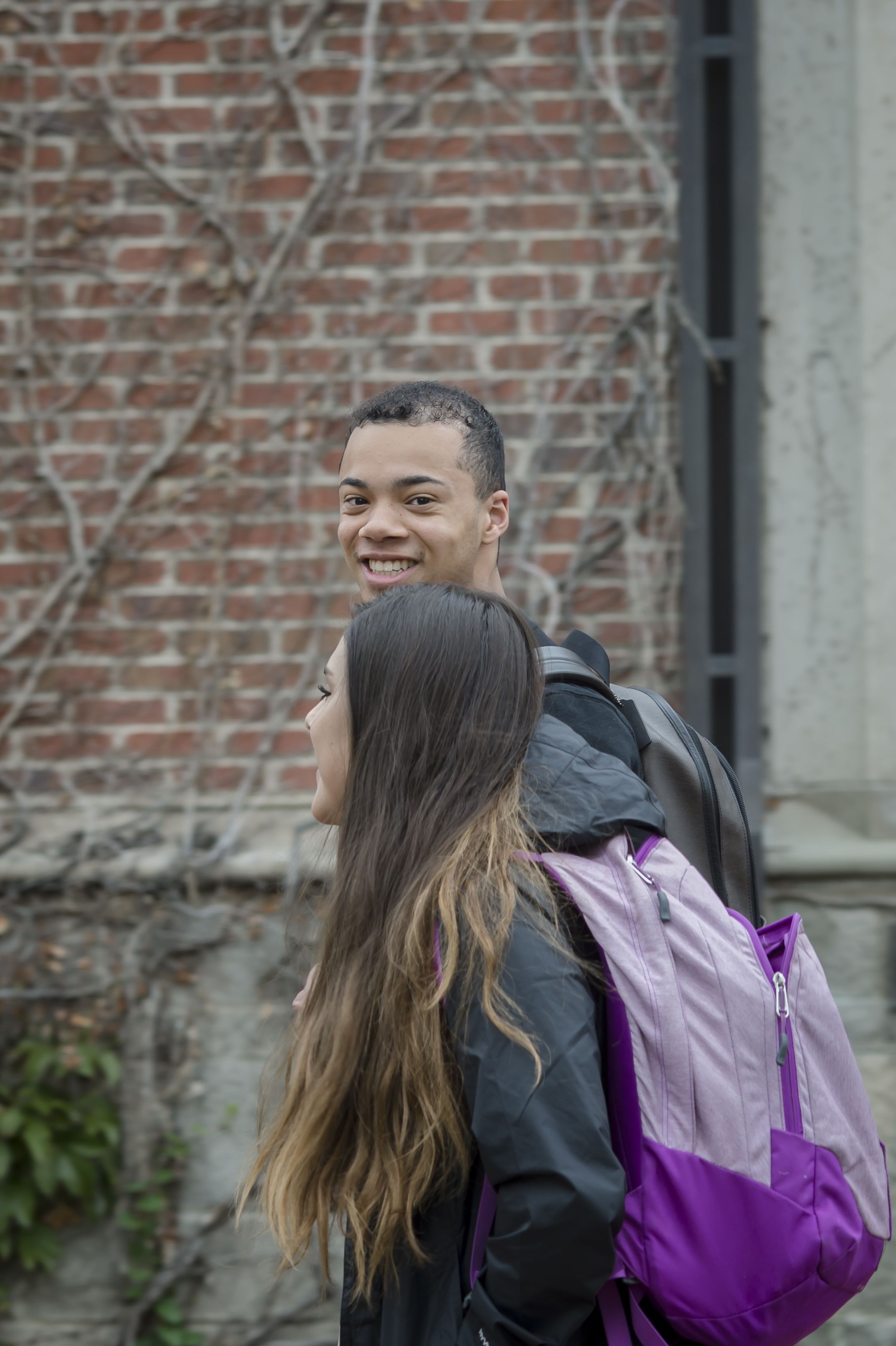 Two students walk on campus