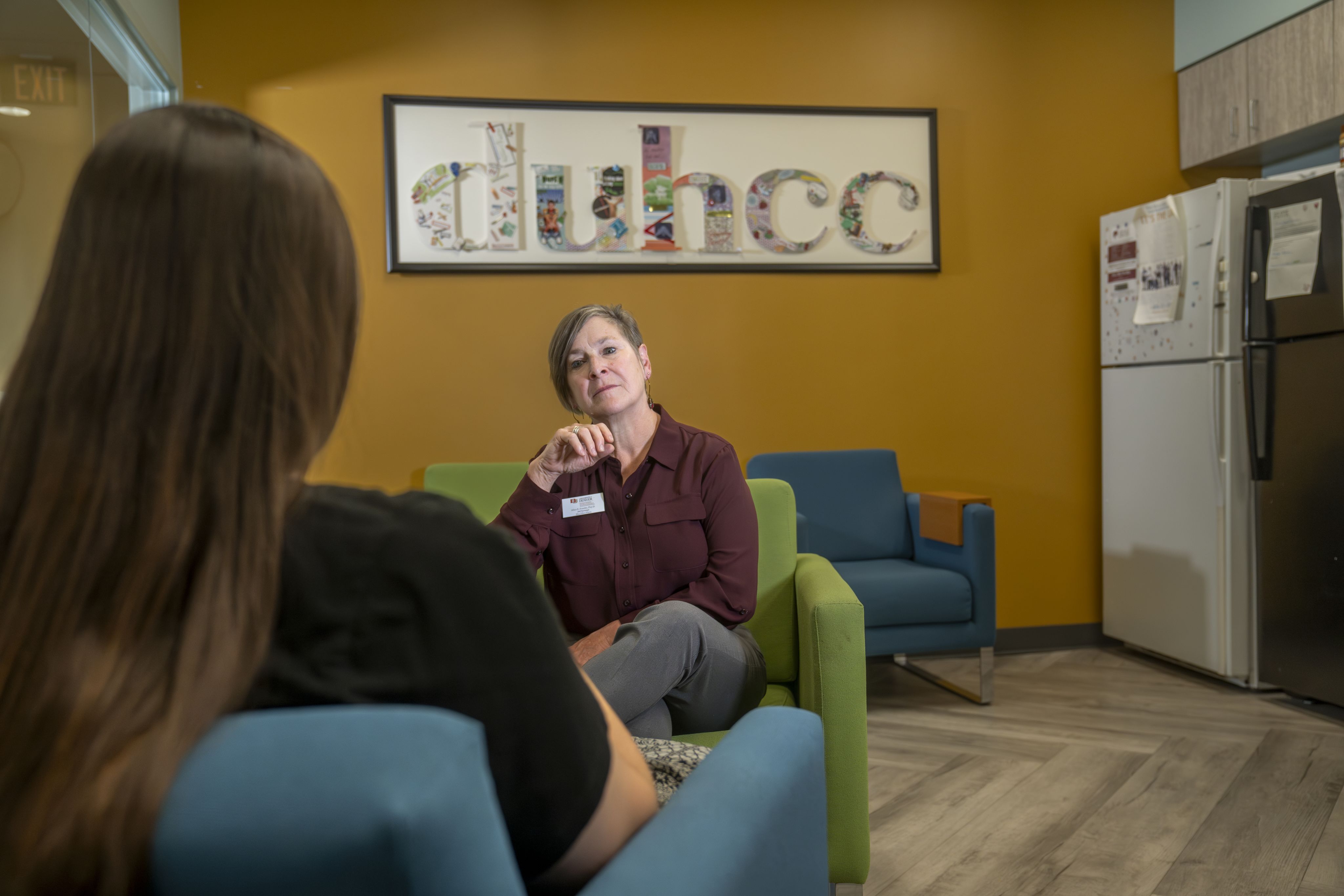 A therapist listens to a student client