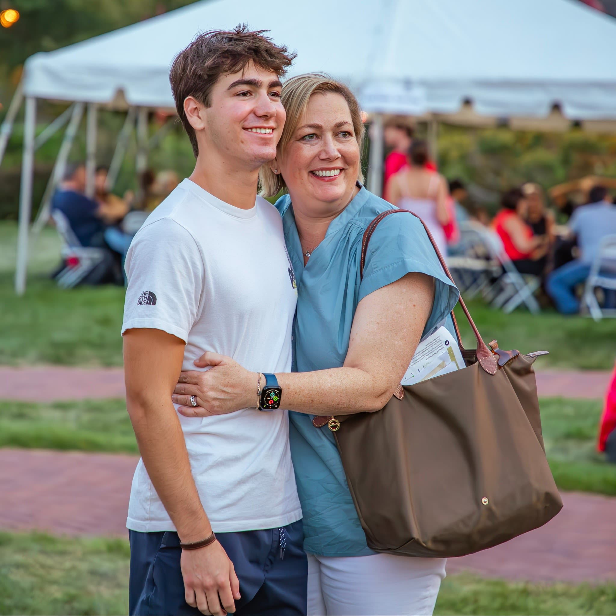 A DU student and their mom pose hugging during Family Weekend
