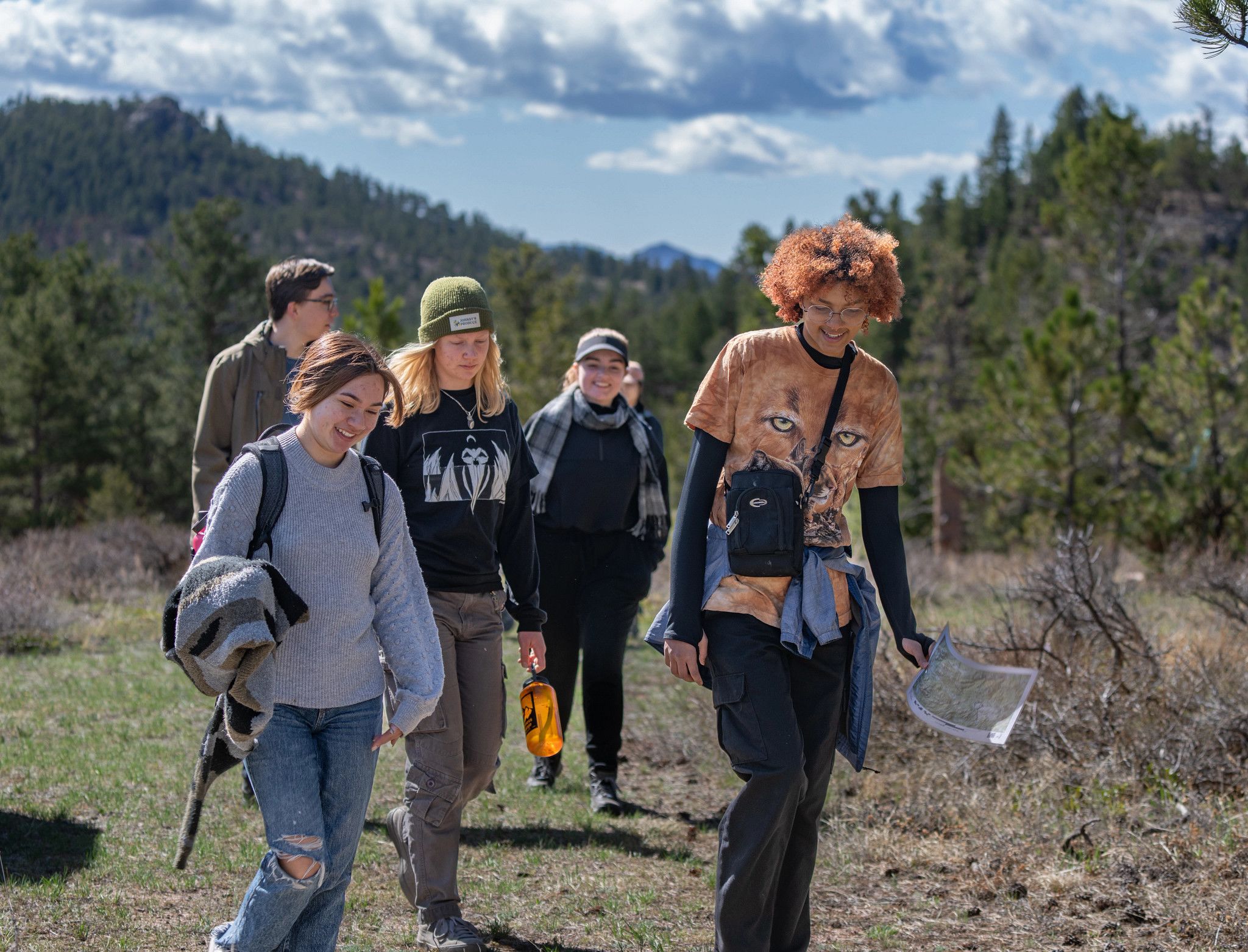A group of students walk in nature at DU Kennedy Mountain Campus
