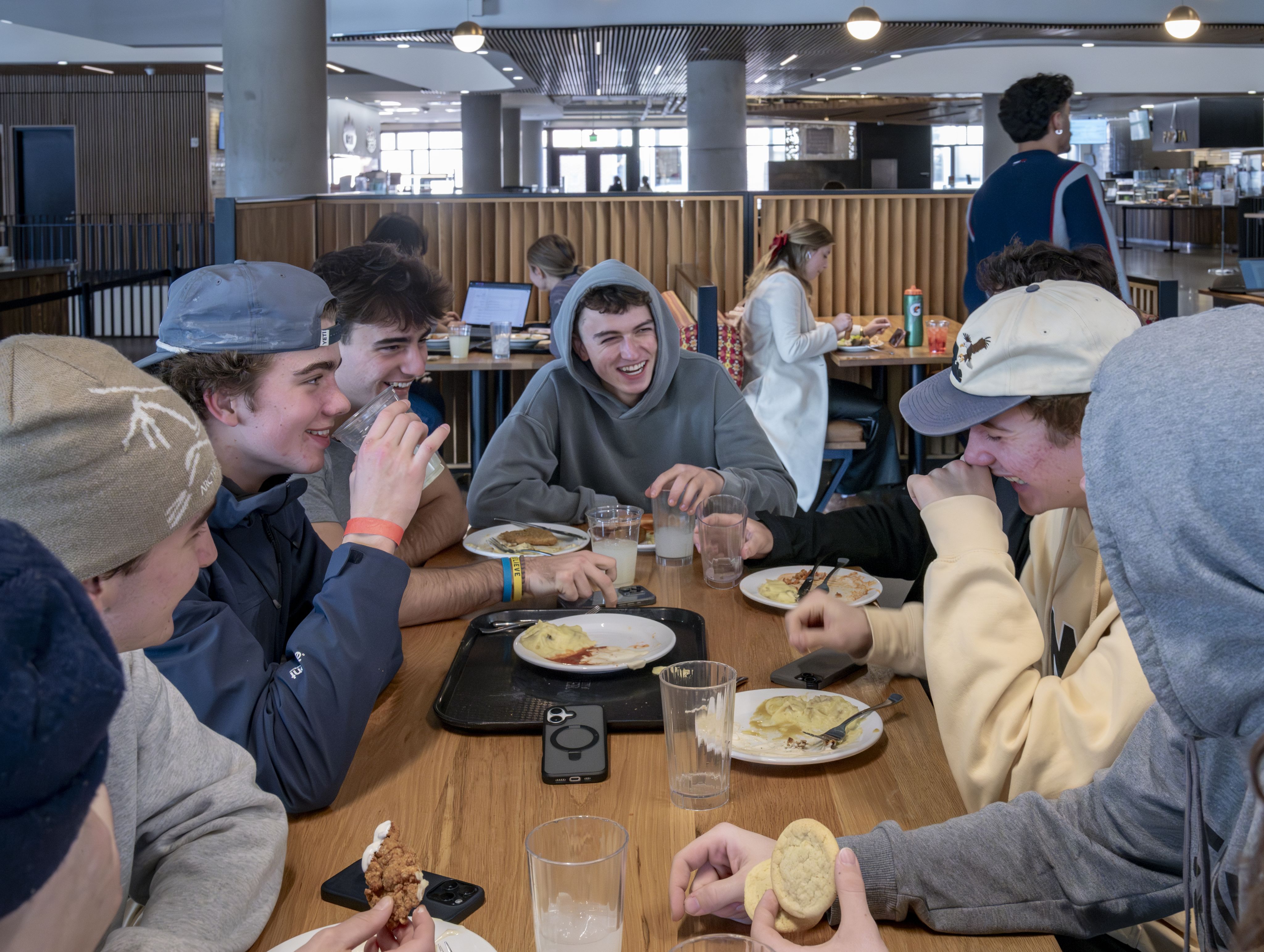 Student laugh while sitting at a table in the DU dining hall