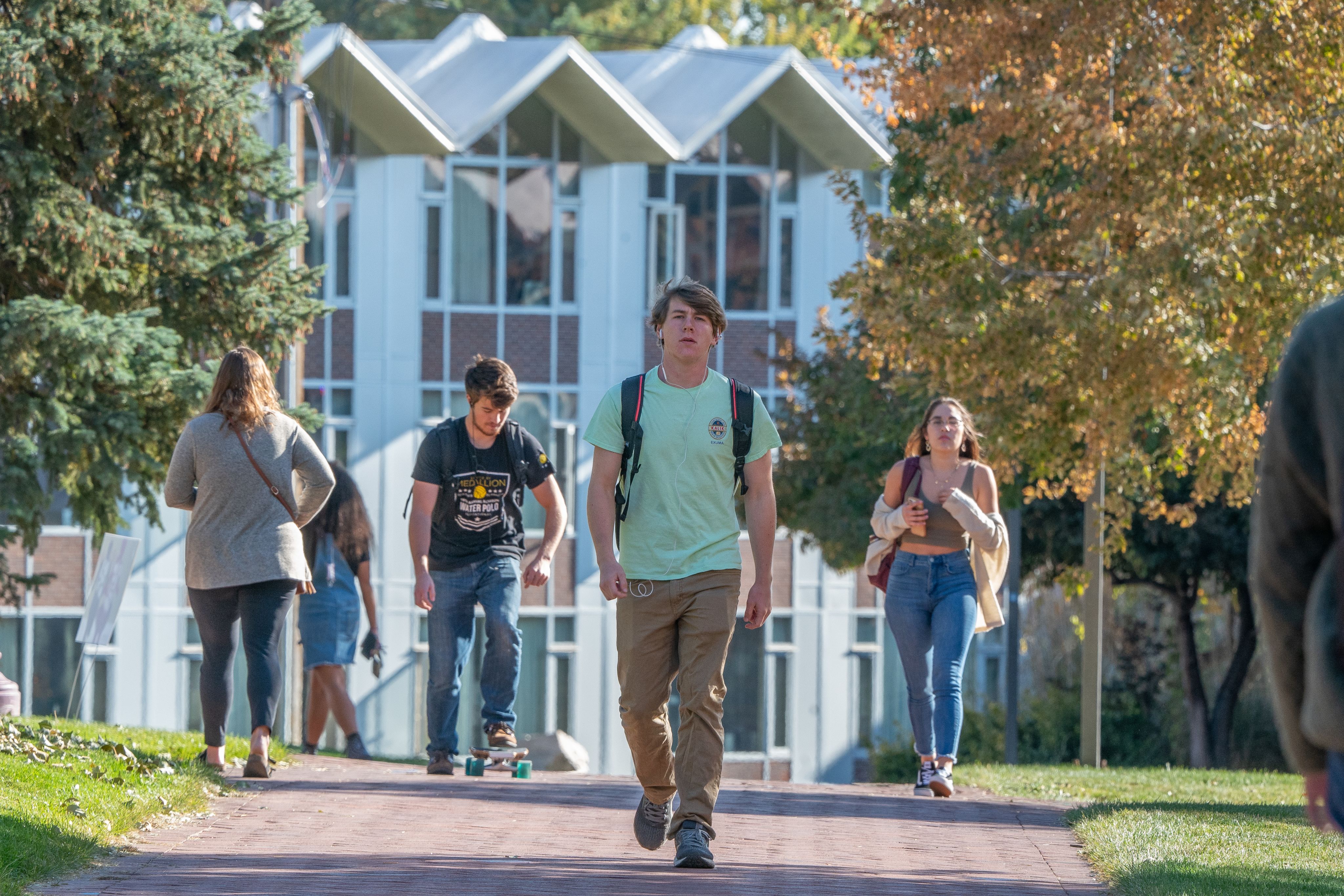 Du students walking on campus in front of dorms